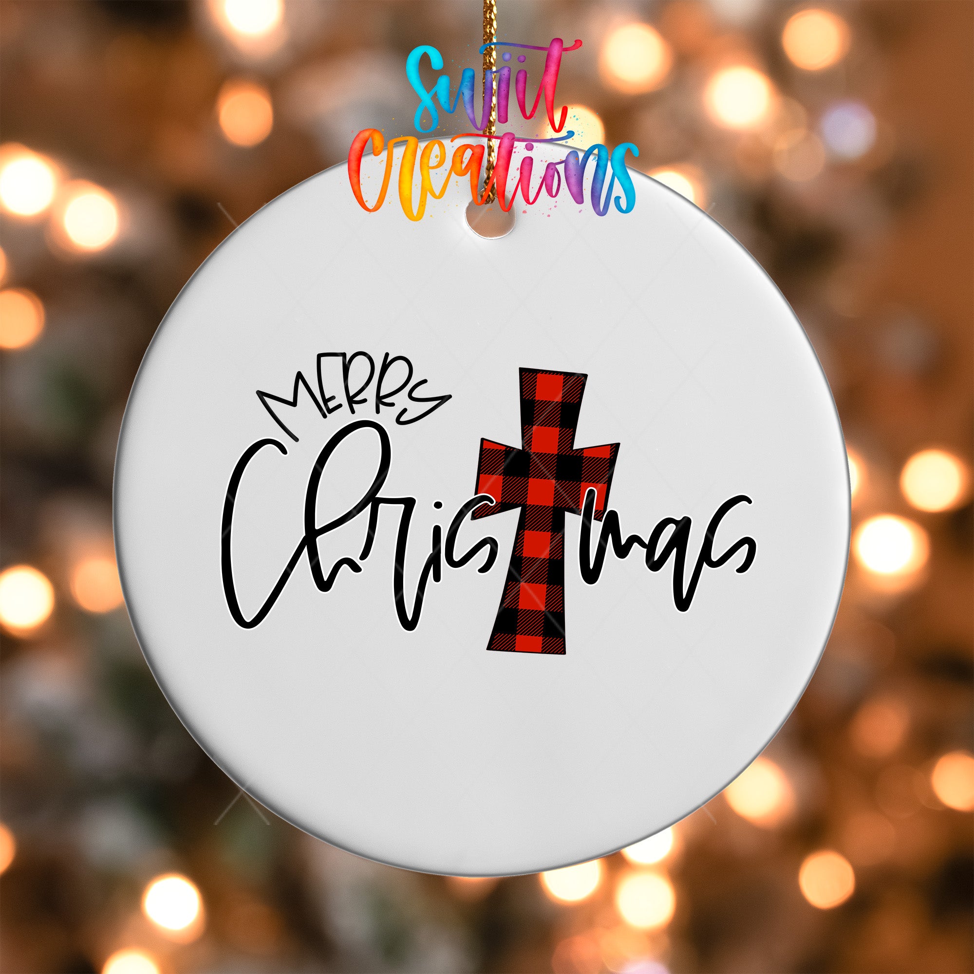 A white Christmas ornament with the text "Merry Christmas" and a red and black plaid cross design.