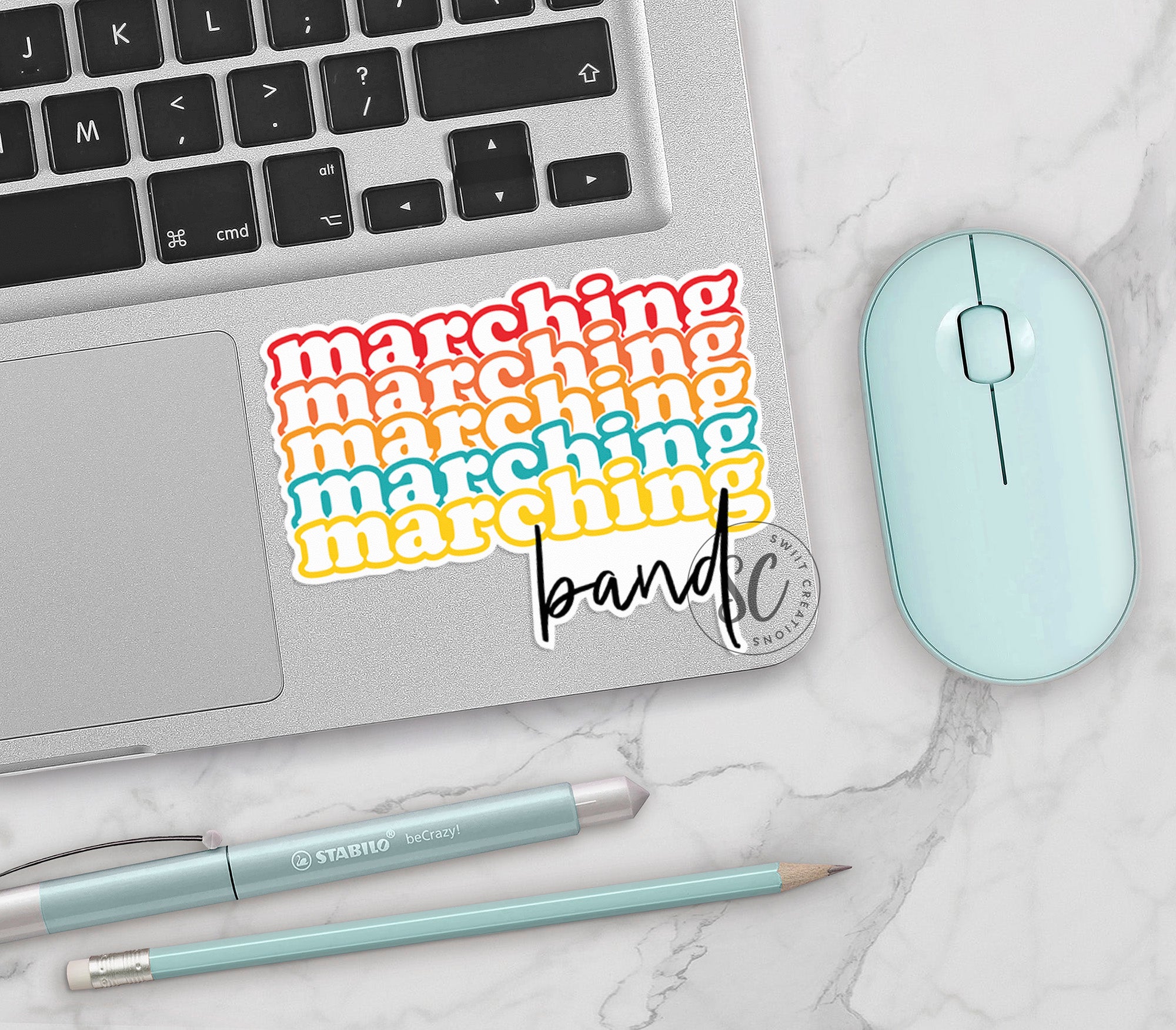 a keyboard, mouse, and sticker on a table