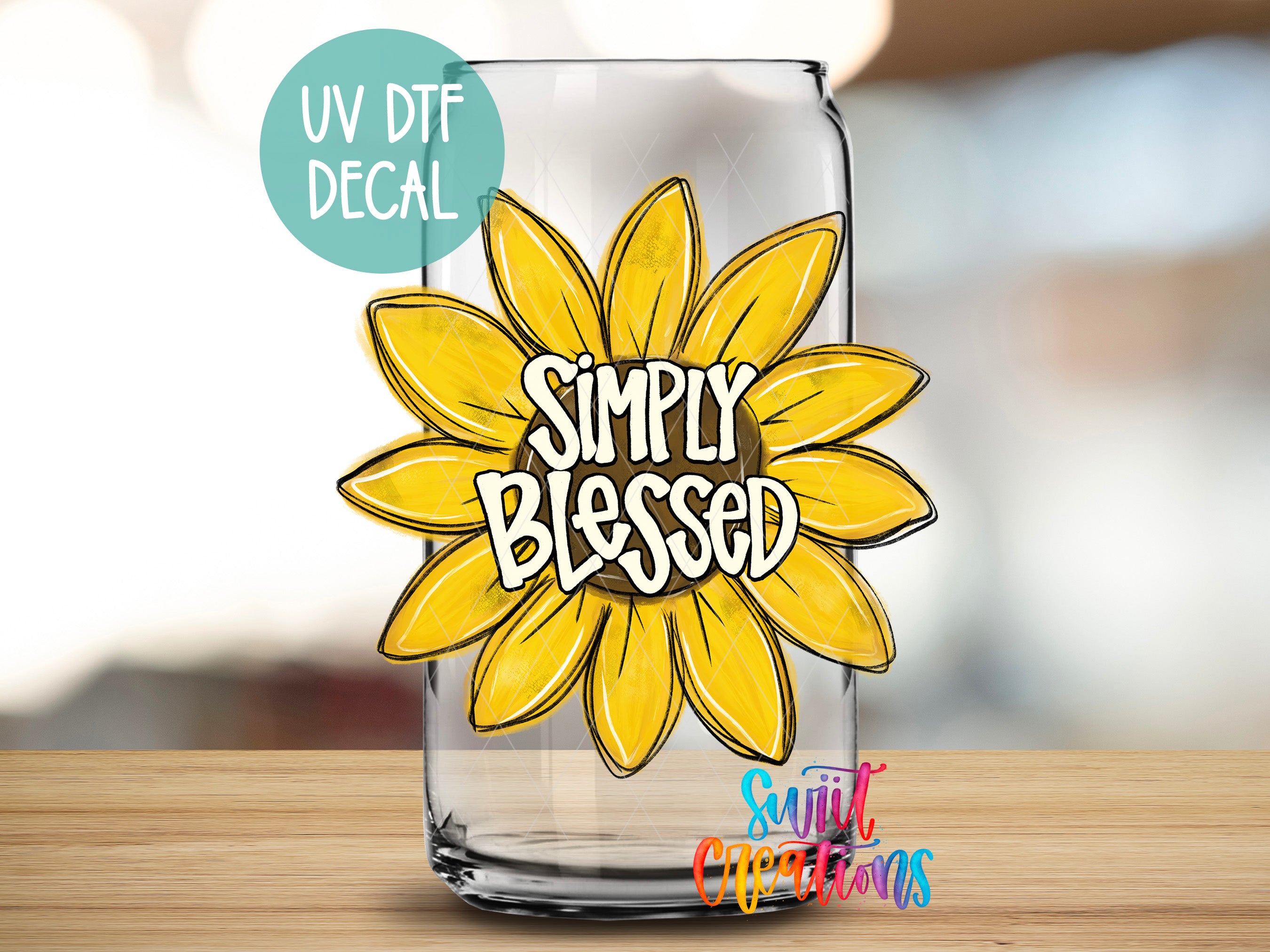 a glass with a sunflower on the side of it