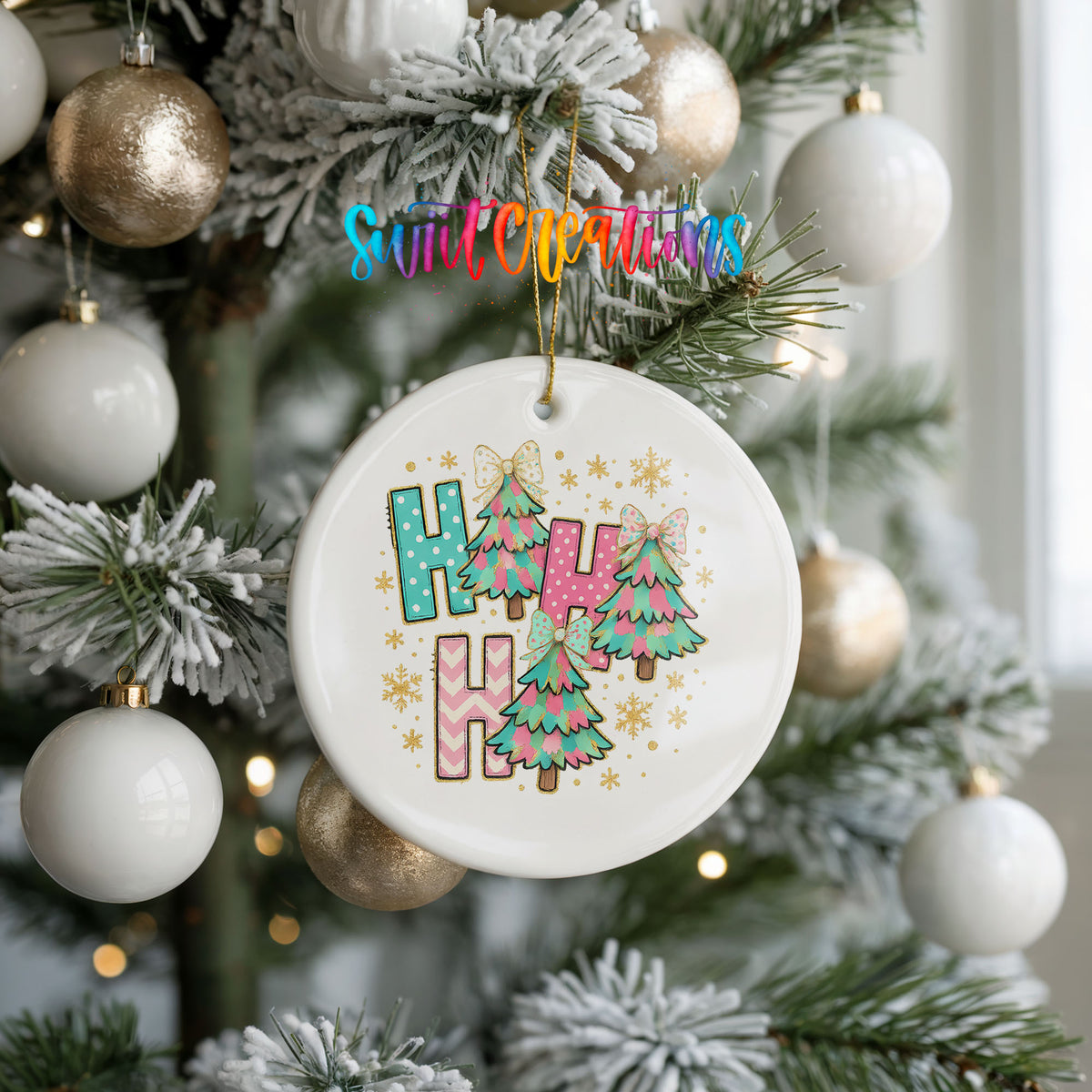 A white ceramic ornament with a colorful design hangs from a Christmas tree, surrounded by white and gold ornaments.