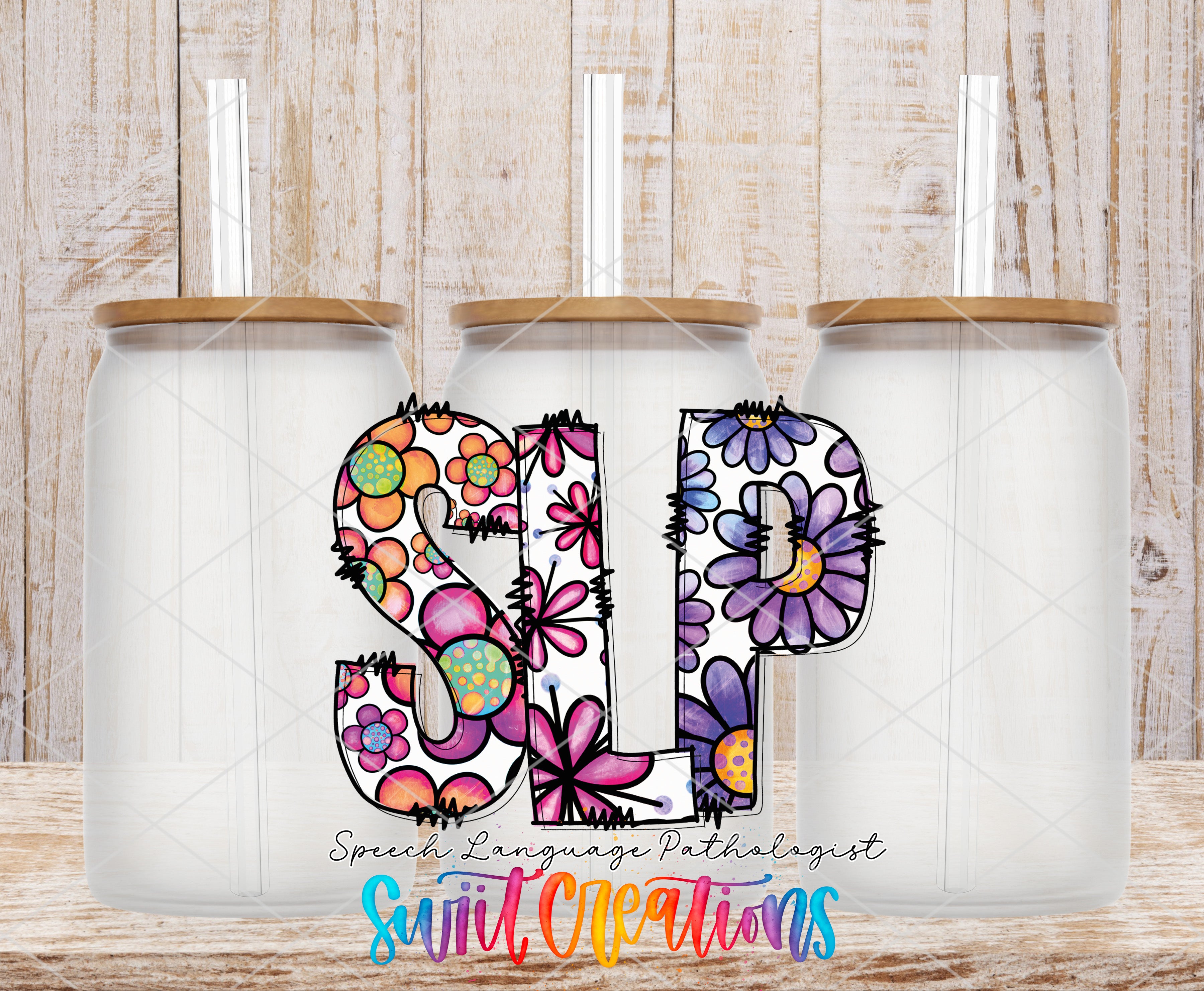 three glass jars with colorful flower designs on them, arranged in a row against a wooden background.