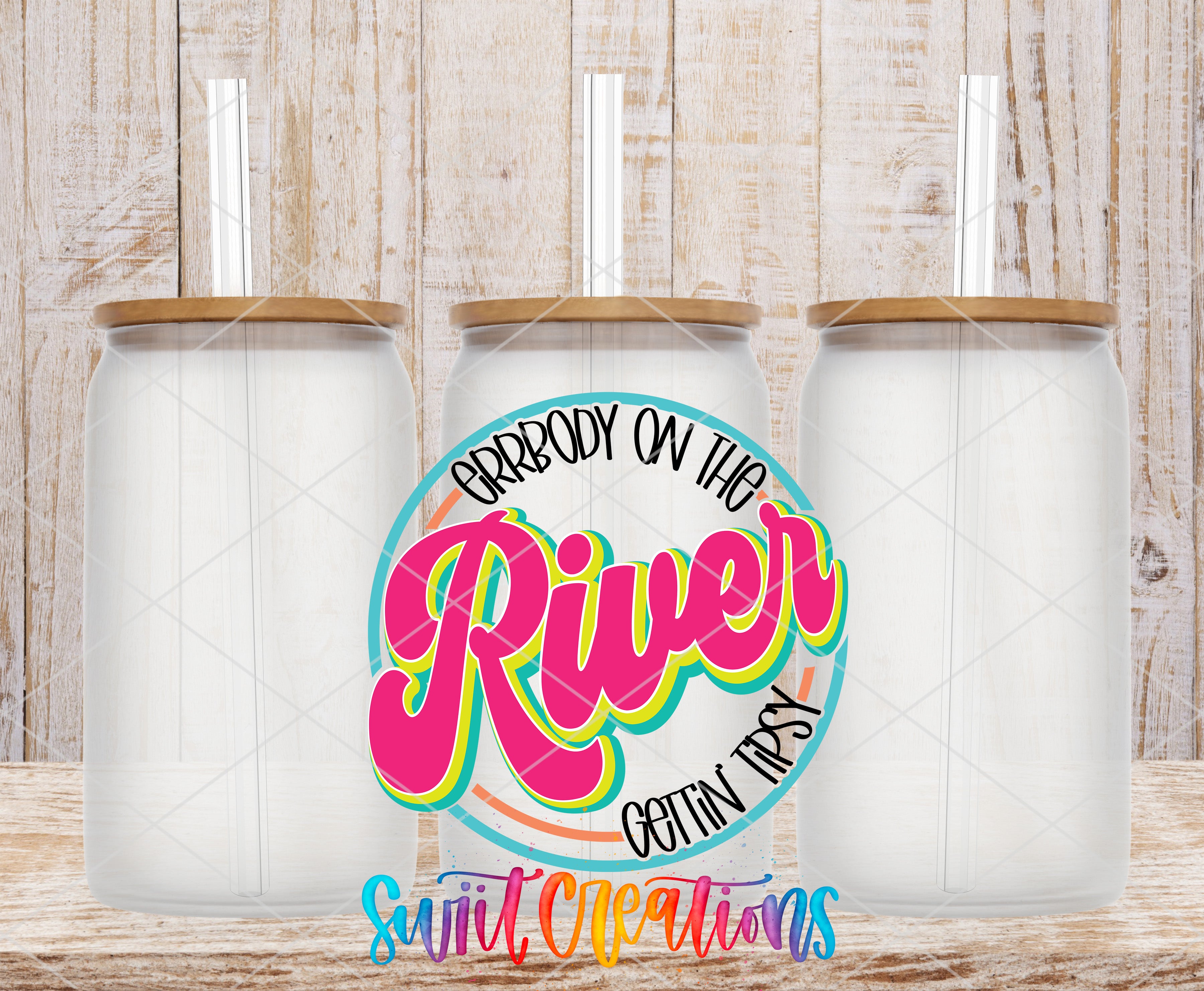 A colorful logo featuring the text "ARRBODY ON THE RIVER GETtinFIRsy" surrounded by a circular design with a rainbow-colored border. Three glass jars with lids are placed in front of the logo, which is set against a wooden background.