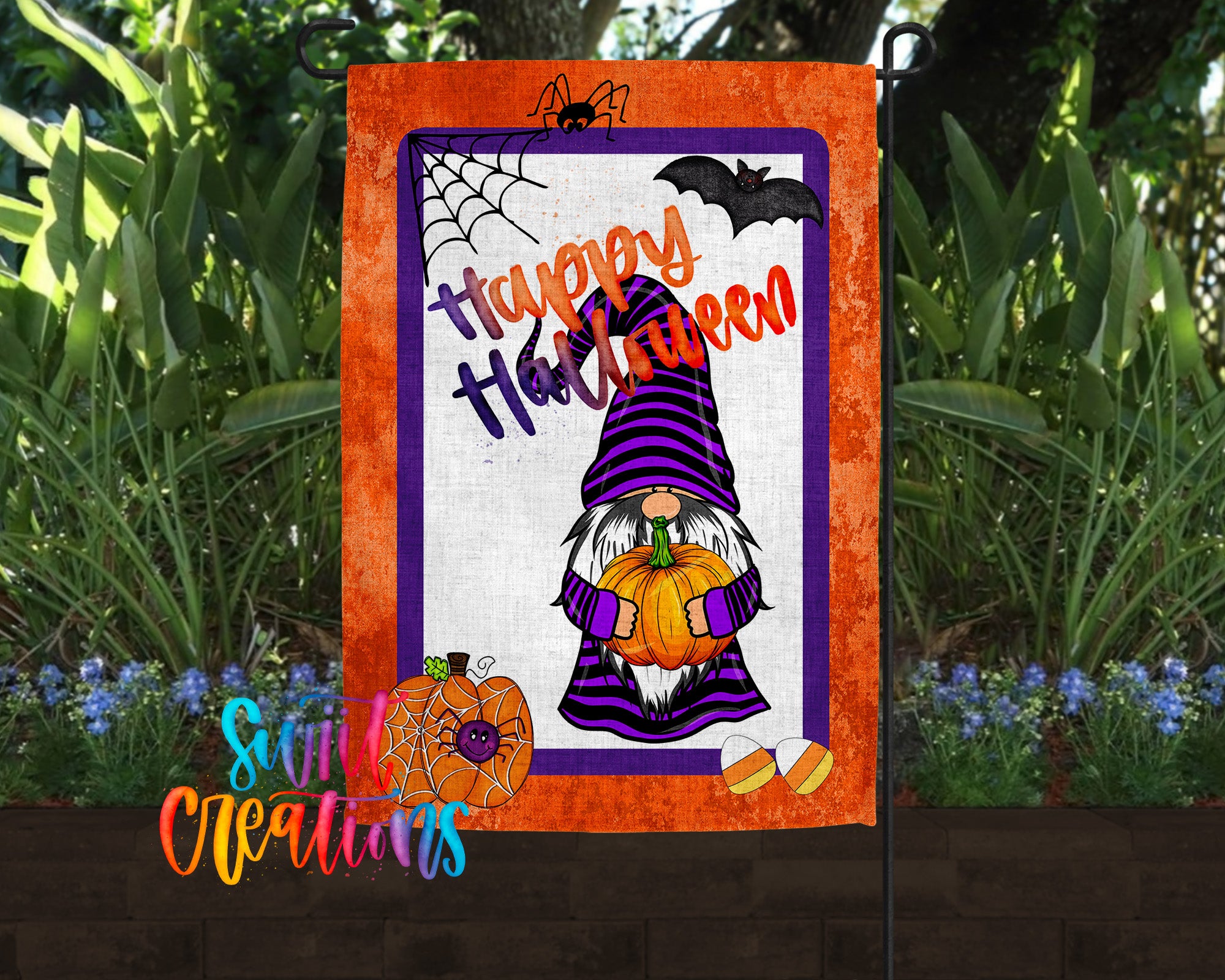 a Halloween-themed garden sign with a gnome holding a pumpkin and a spider web. The sign is surrounded by greenery and flowers, creating a festive atmosphere.