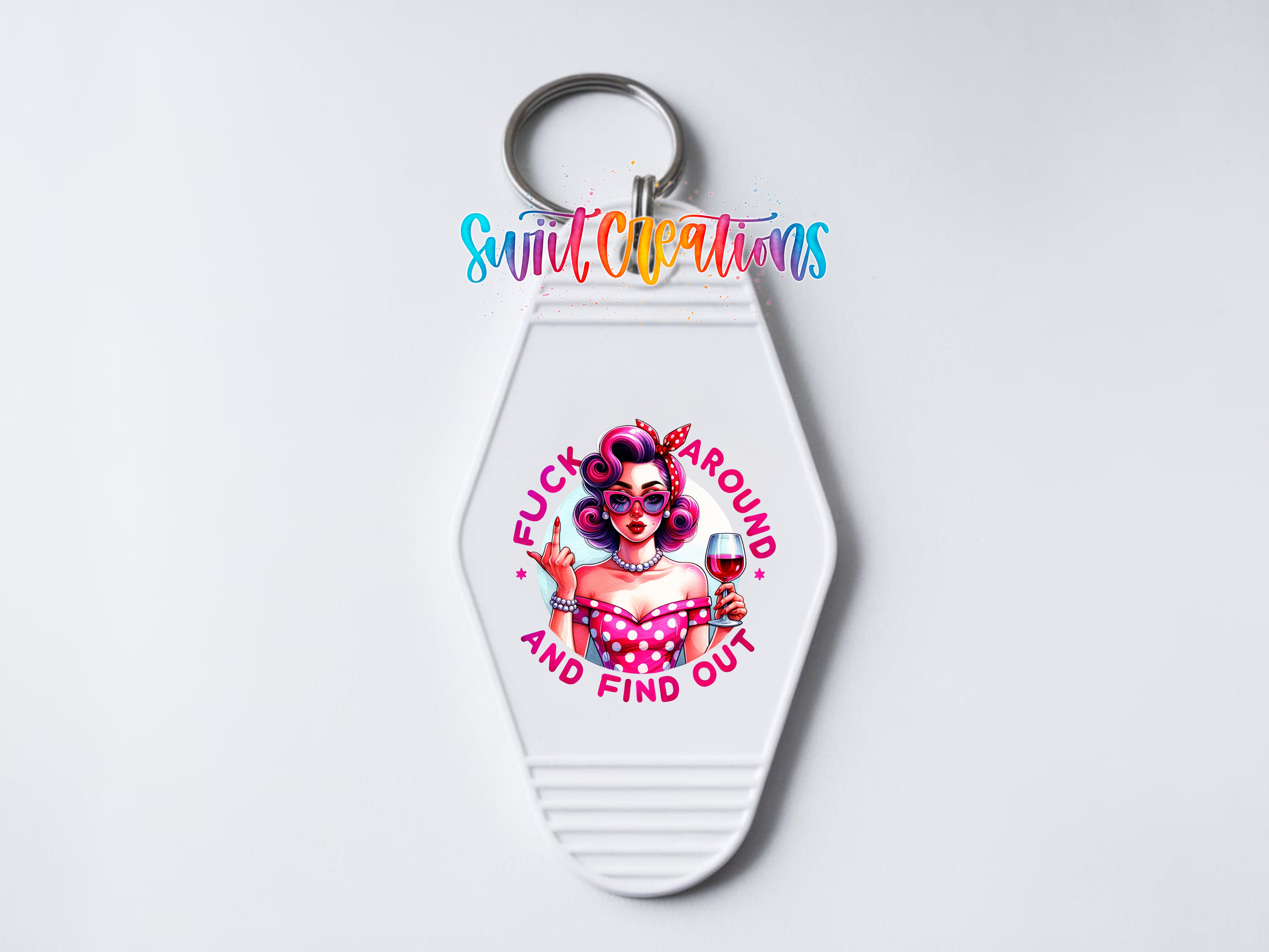 A keychain with a colorful design featuring a woman with curly hair and a pink polka dot dress, holding a wine glass and a microphone.