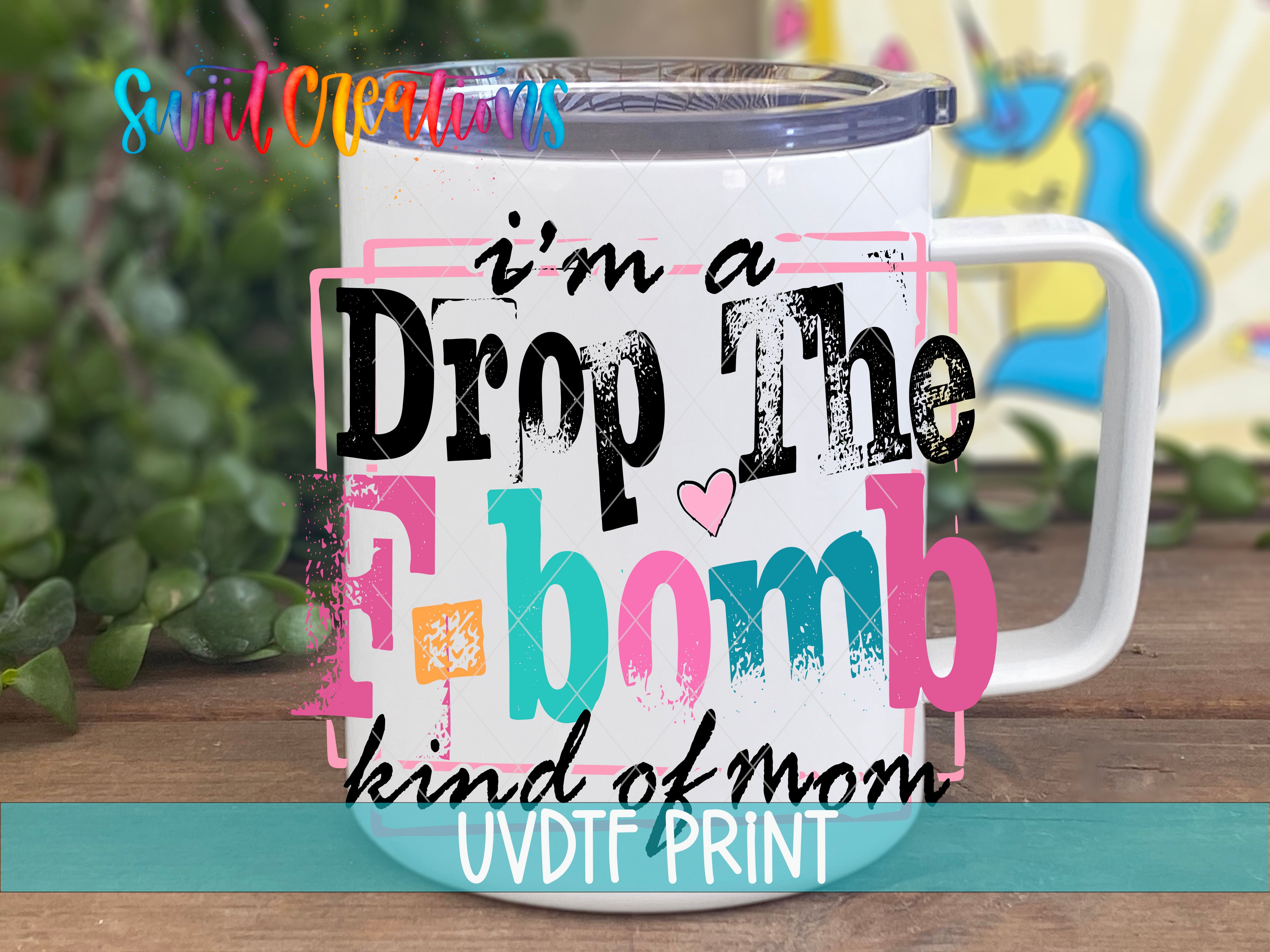 A white mug with colorful text and graphics on it, placed on a wooden surface.