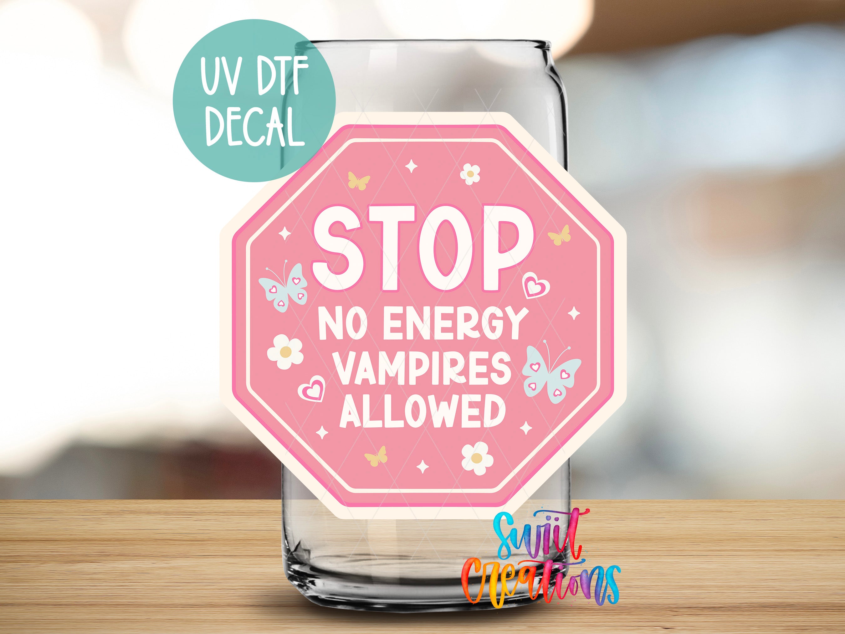 a pink stop sign sitting on top of a wooden table