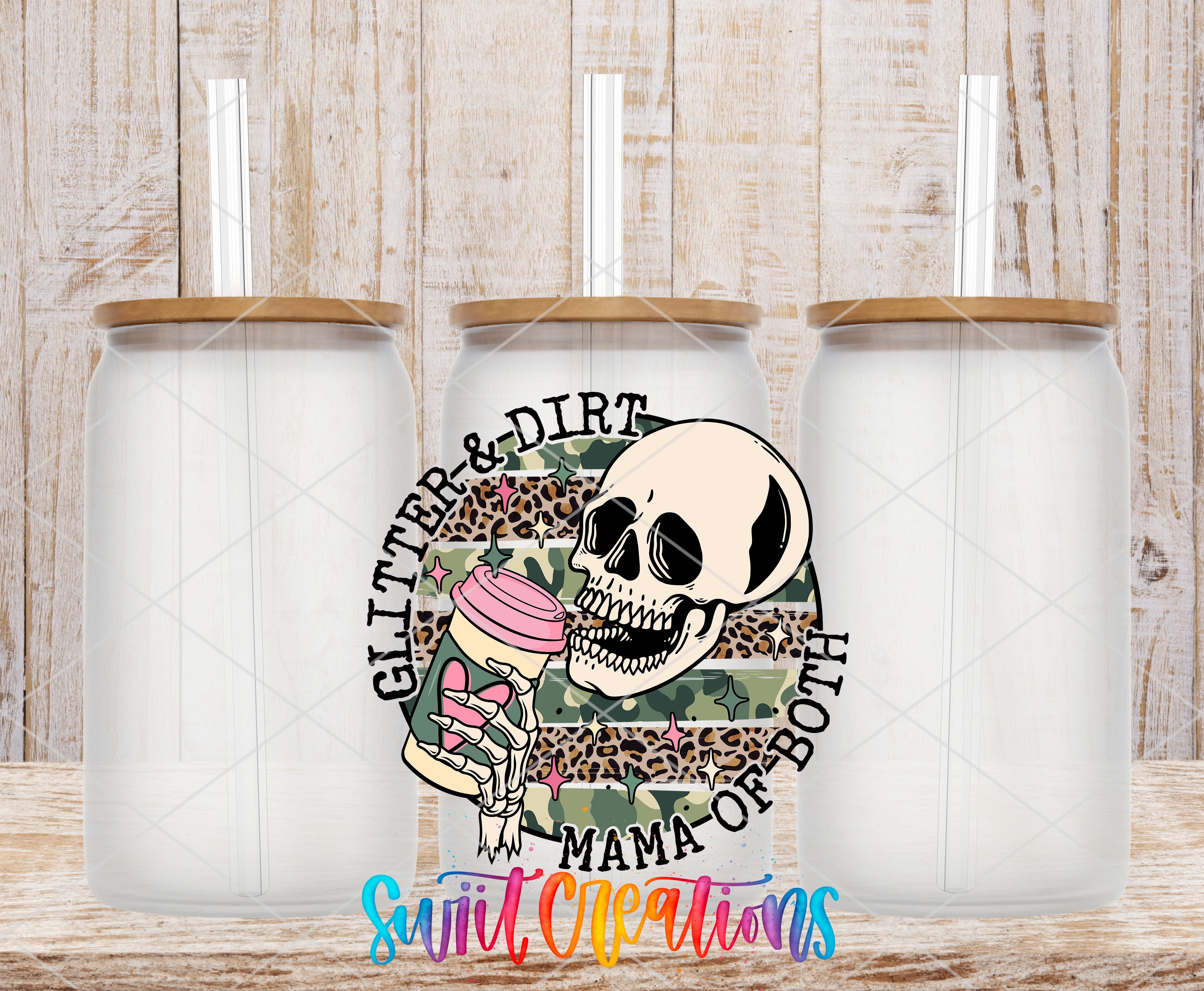 three clear glass jars with lids, arranged in a row against a wooden background. The jars have a skull design on them, and there is text surrounding the skull that reads "Glitter & Dirt Mama of both".