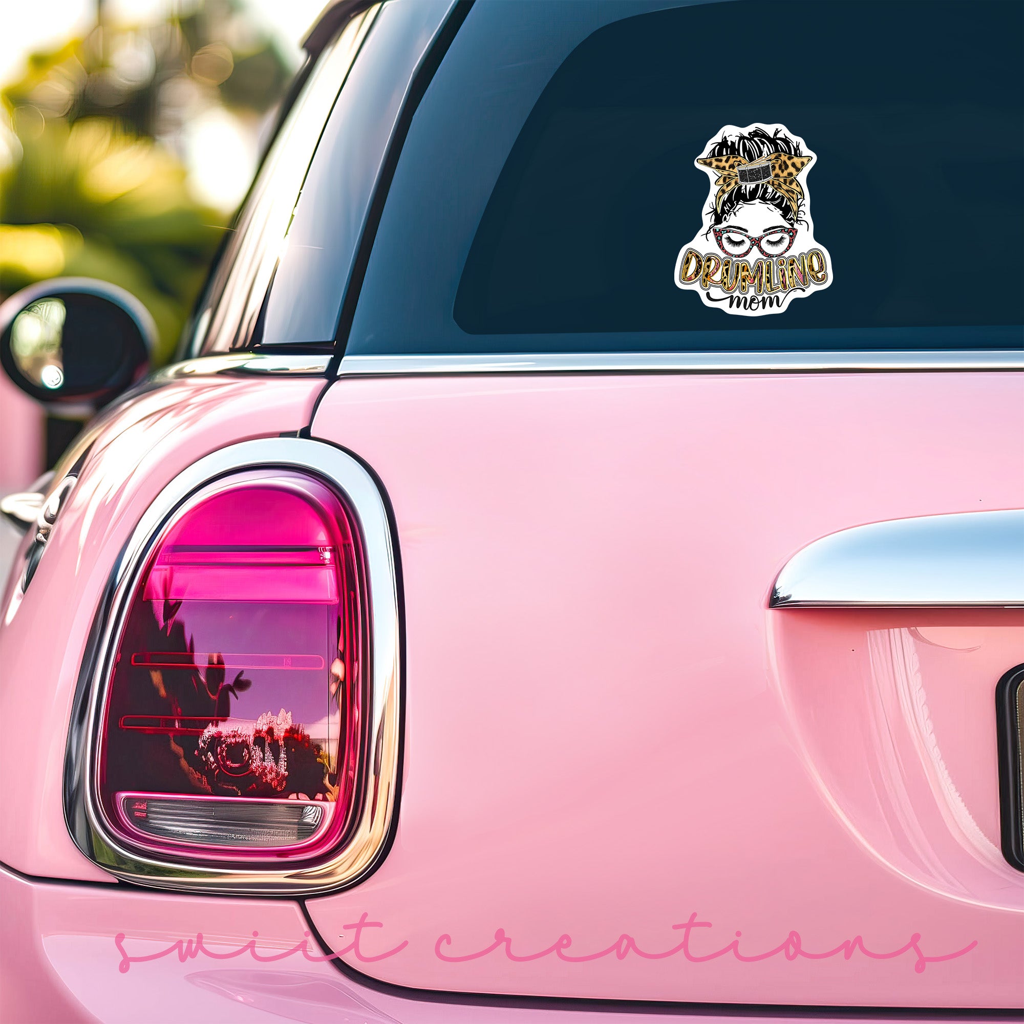 a pink car with a sticker on it