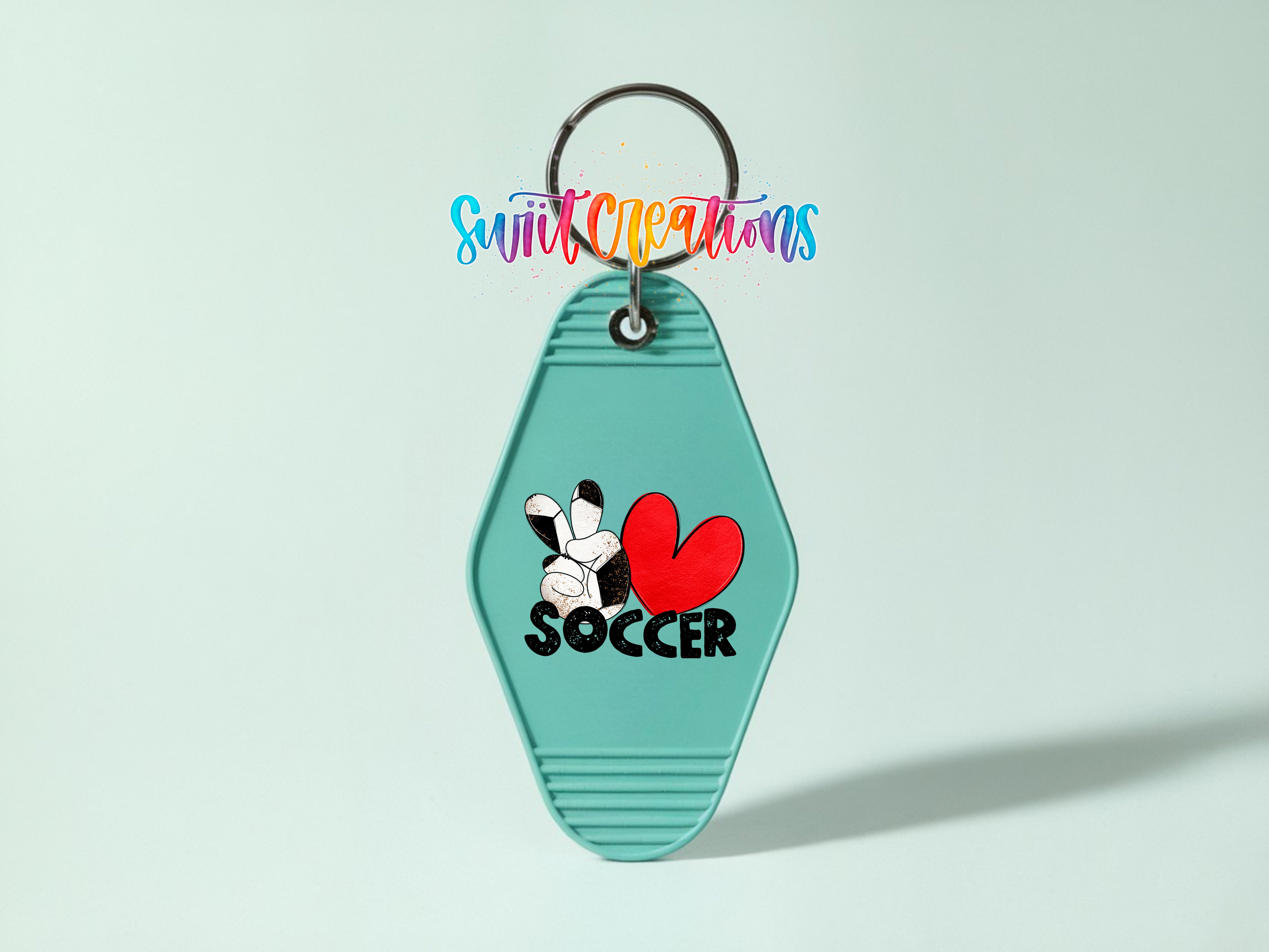 A keychain with a green hexagonal shape and a peace sign, along with the word "SOCCER" printed on it.