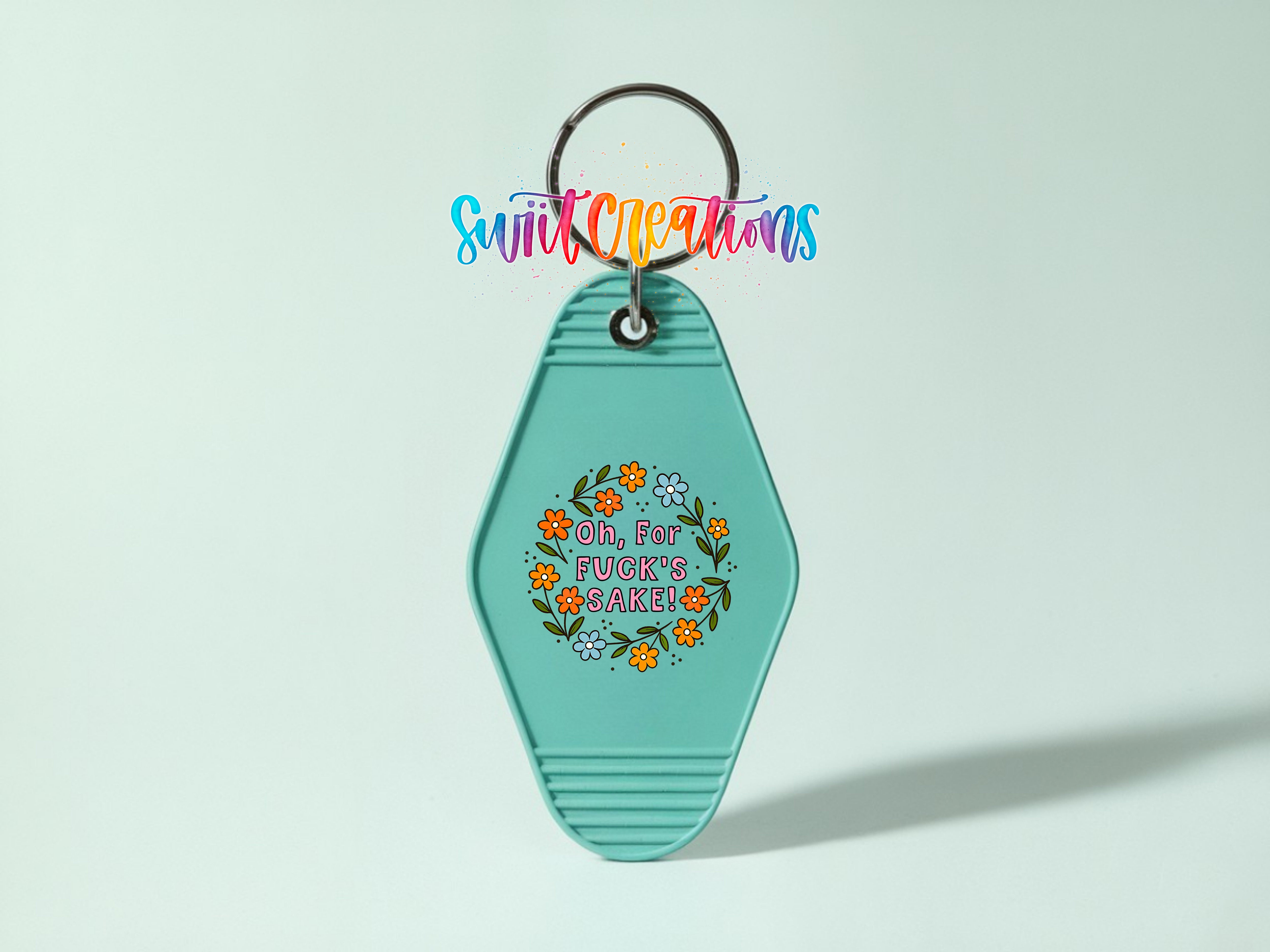 A turquoise keychain with a colorful graphic and text on it.