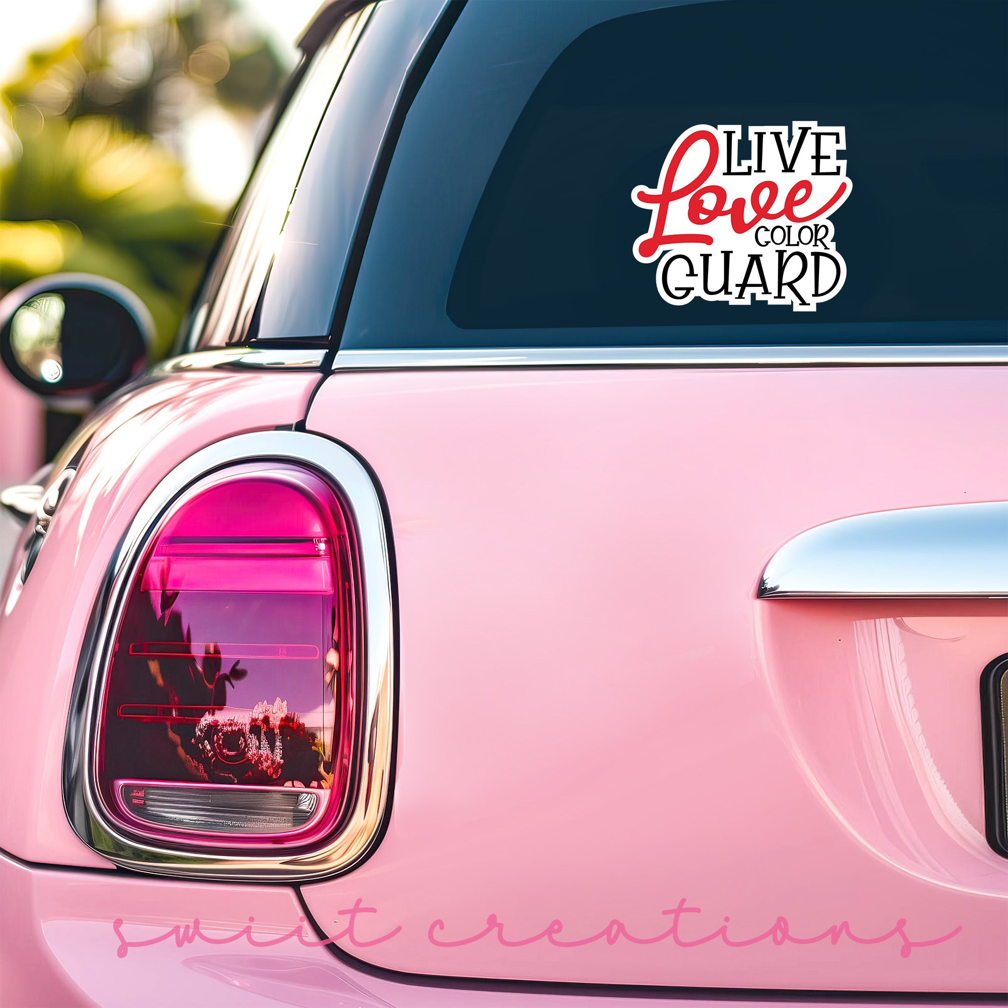 a pink car that has a sticker on it