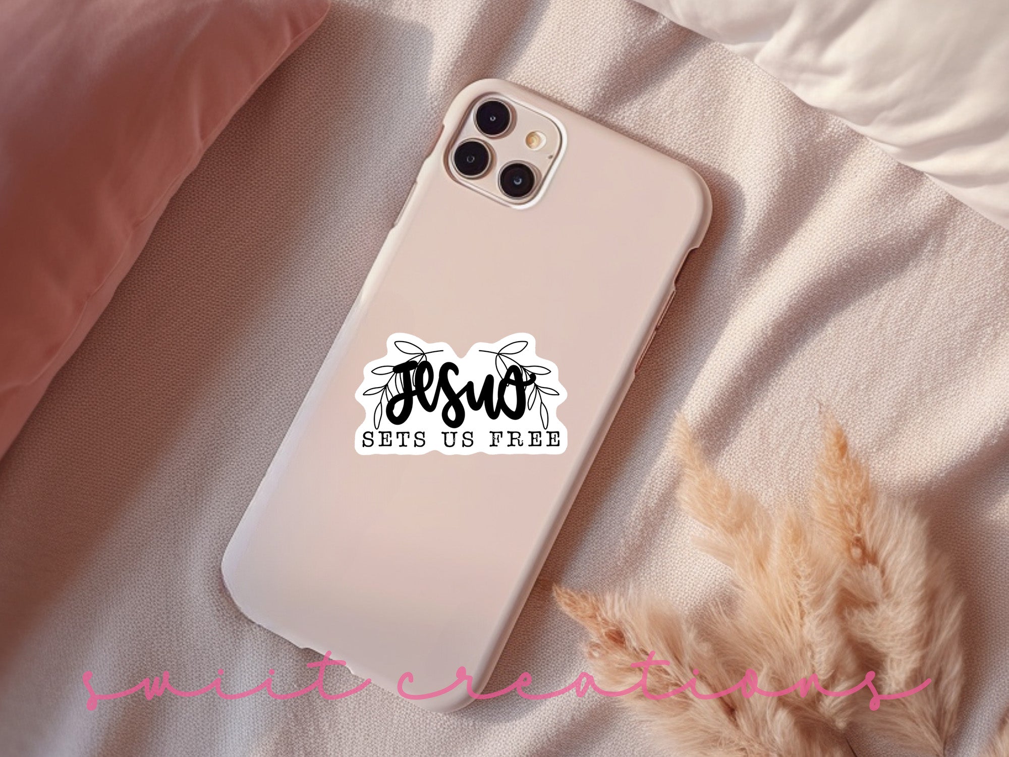 a phone case with a sticker on it sitting on a bed