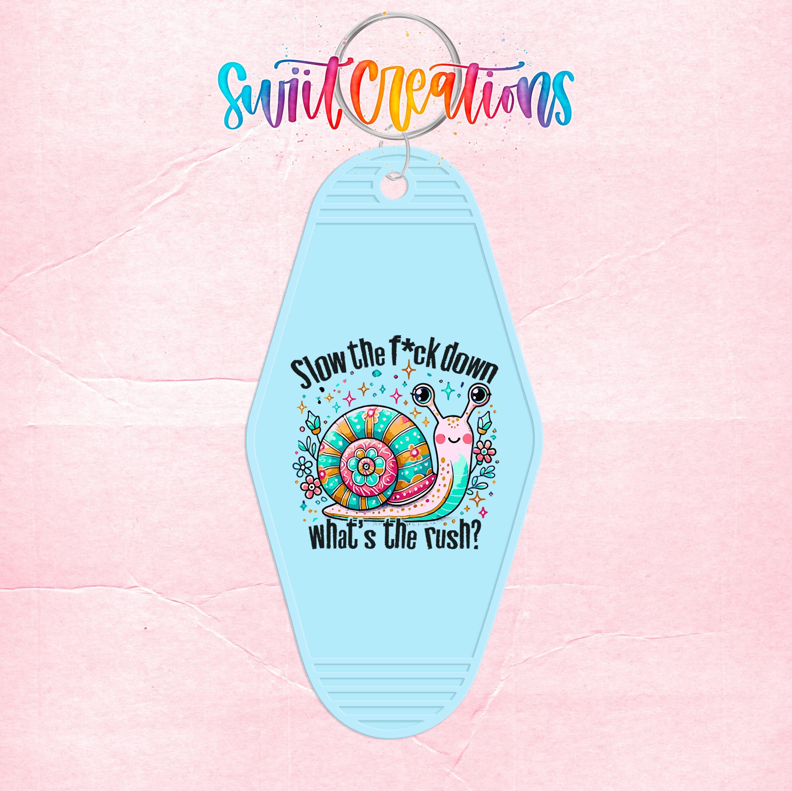 A keychain with a snail design and text that says "Slow the fuck down, what's the rush?"