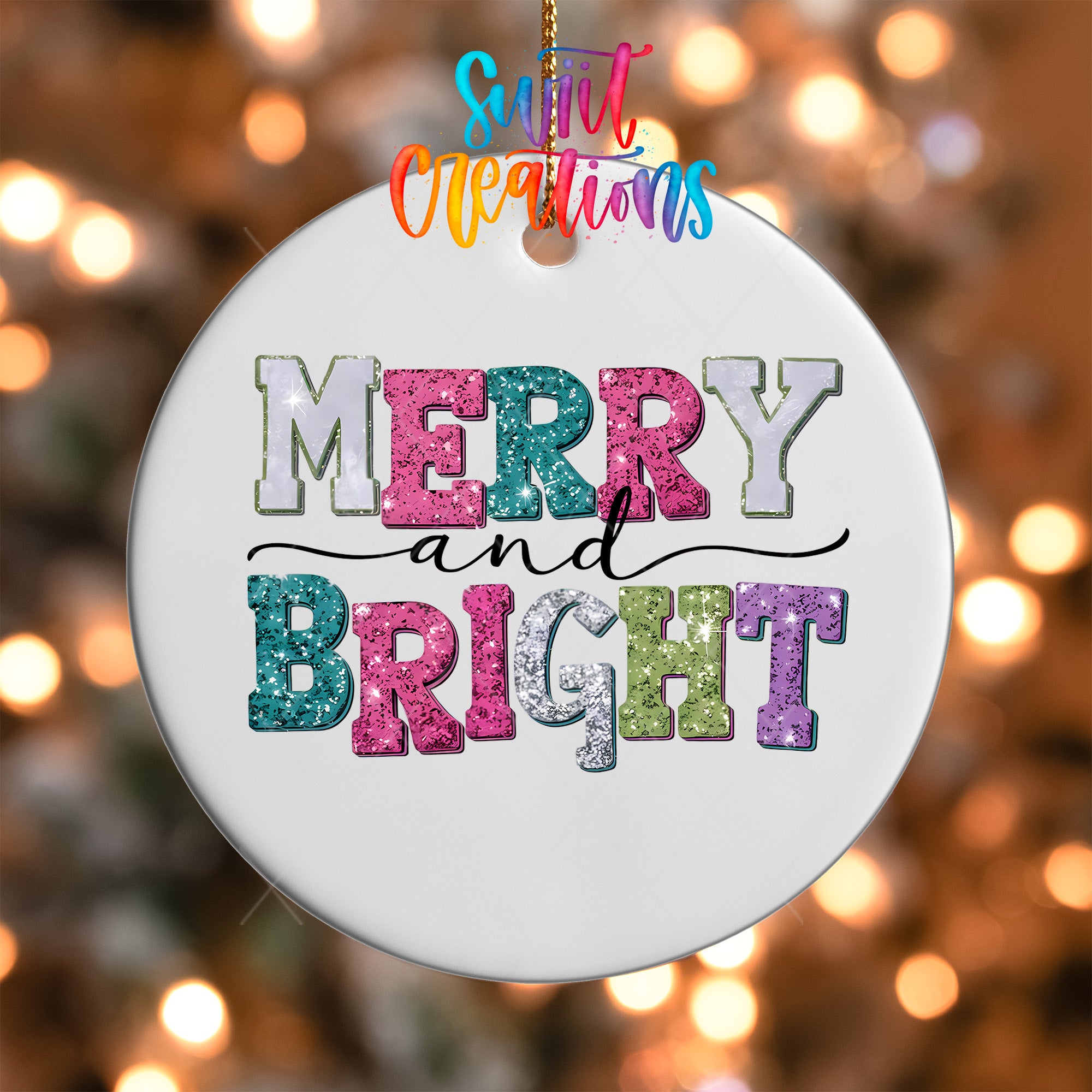 A white ornament with the text "MERRY and BRIGHT" in colorful glitter letters, hanging against a background of blurred lights.