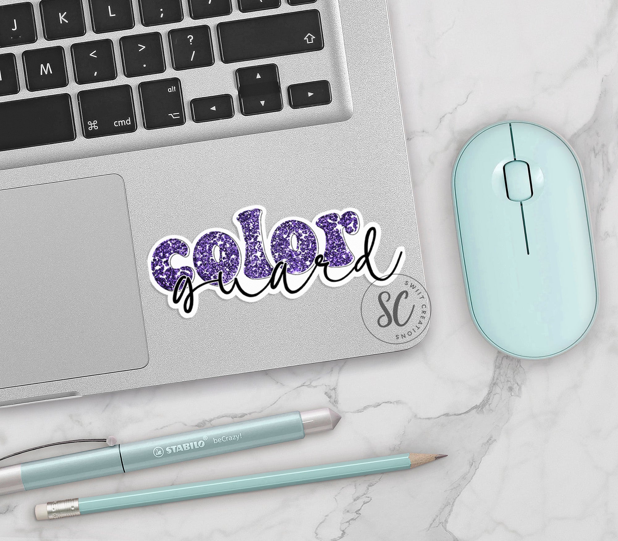 a laptop with a sticker of the word color next to a mouse