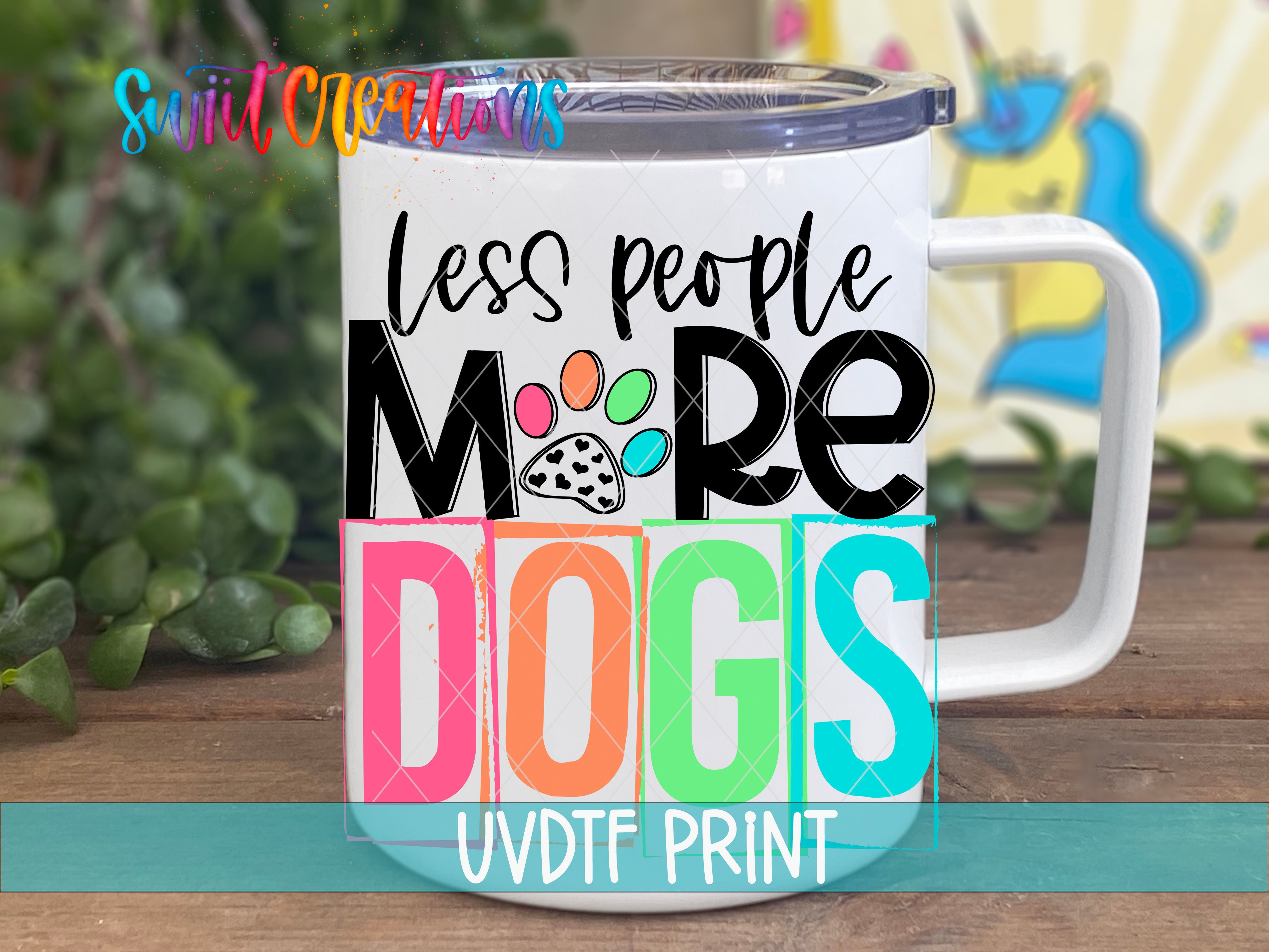 A white mug with colorful text and graphics printed on it, placed on a wooden surface.