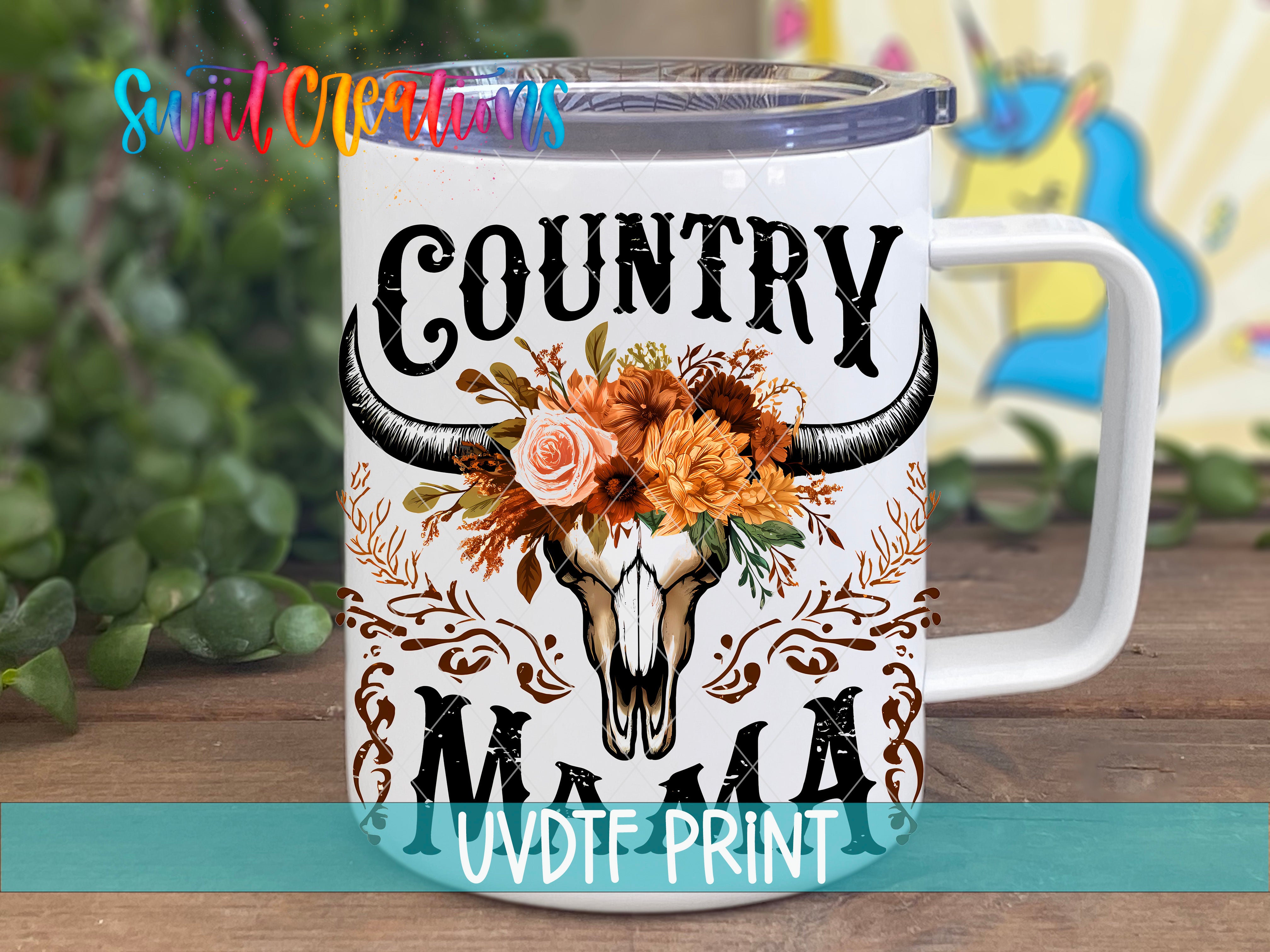 A white ceramic mug with a floral design and the text "COUNTRY MAMA" printed on it.