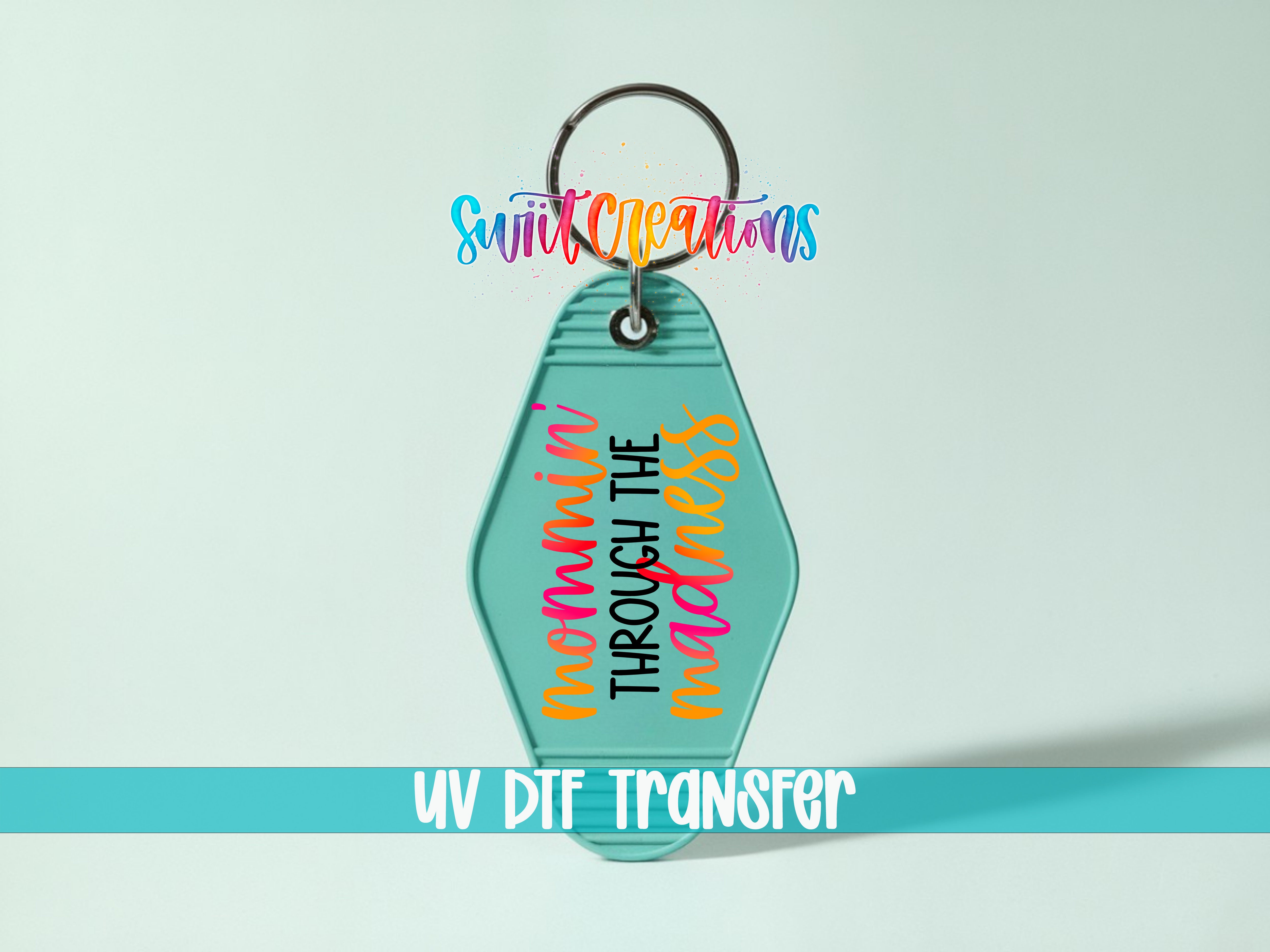 A keychain with a colorful design and text, including the words "Sunlit Creations" and "UV DIF TRANSFER".