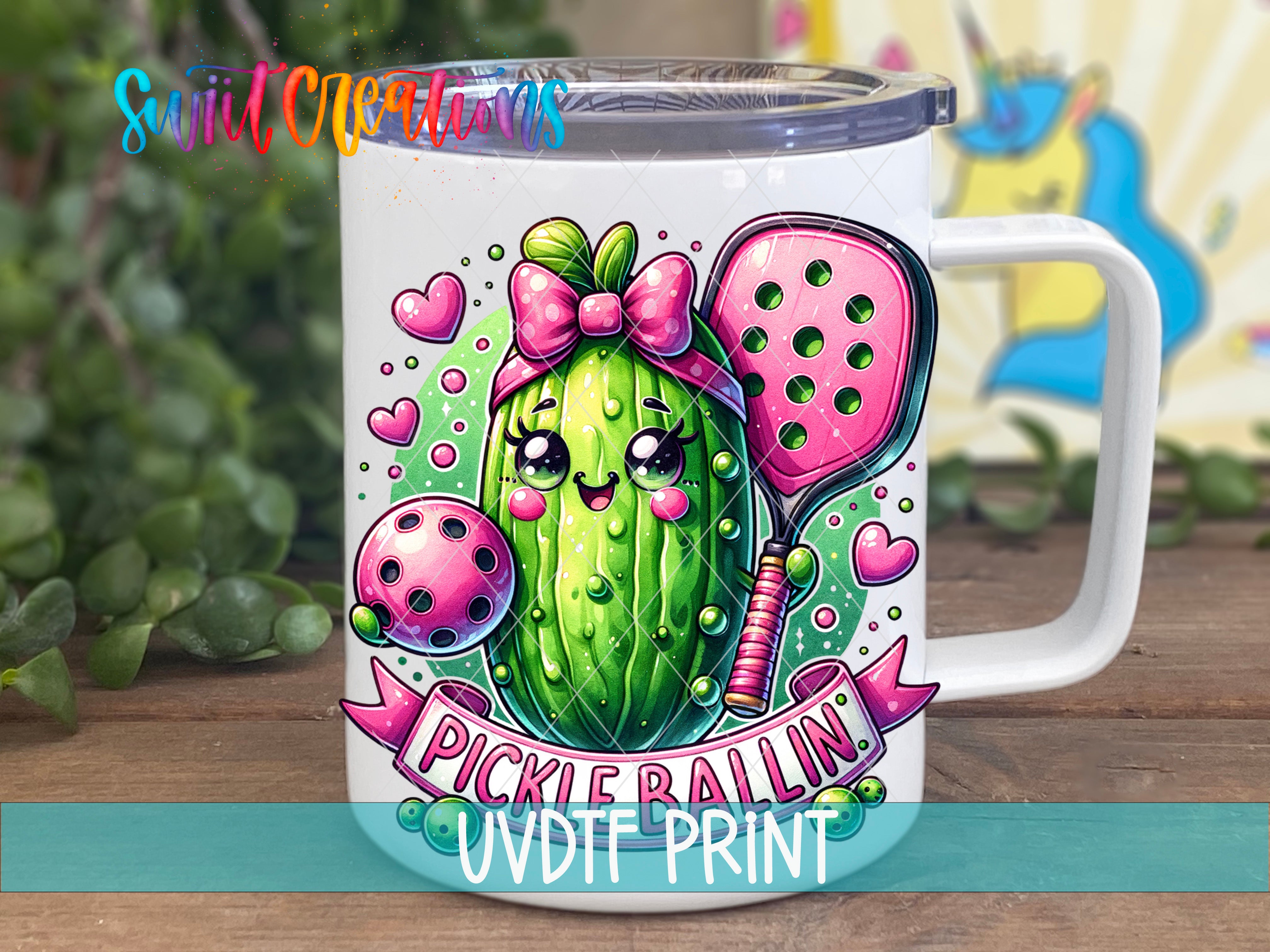 A white mug with a colorful illustration of a pickle on it, featuring a bow and hearts.