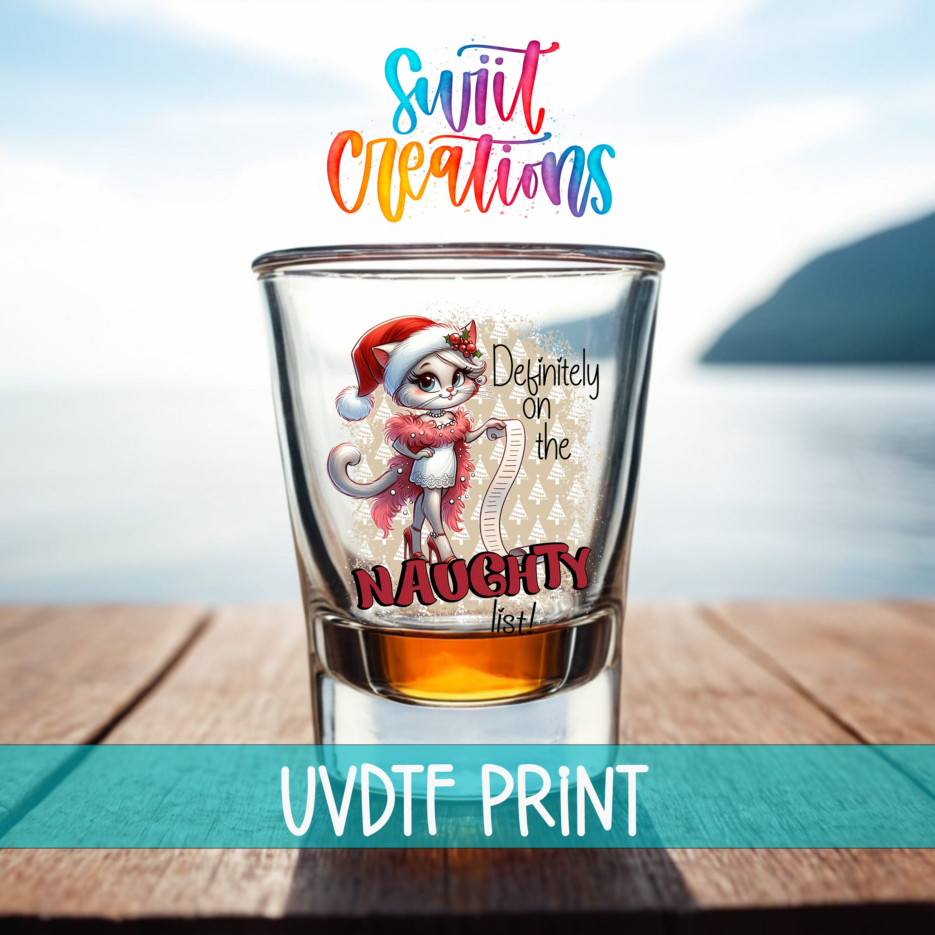A shot glass with a cartoon character on it, placed on a wooden surface with a body of water in the background.
