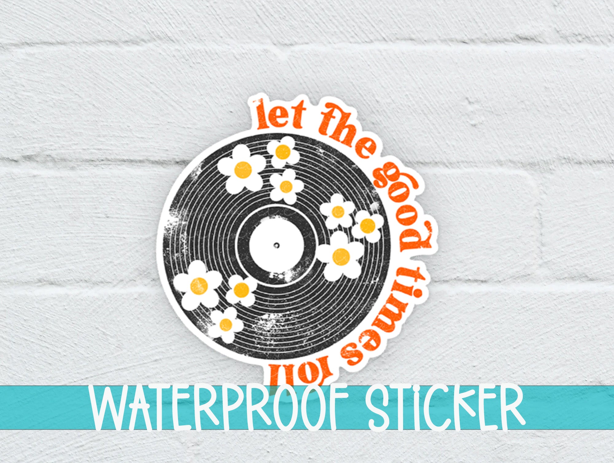 a white brick wall with a sticker of a record with daisies on it