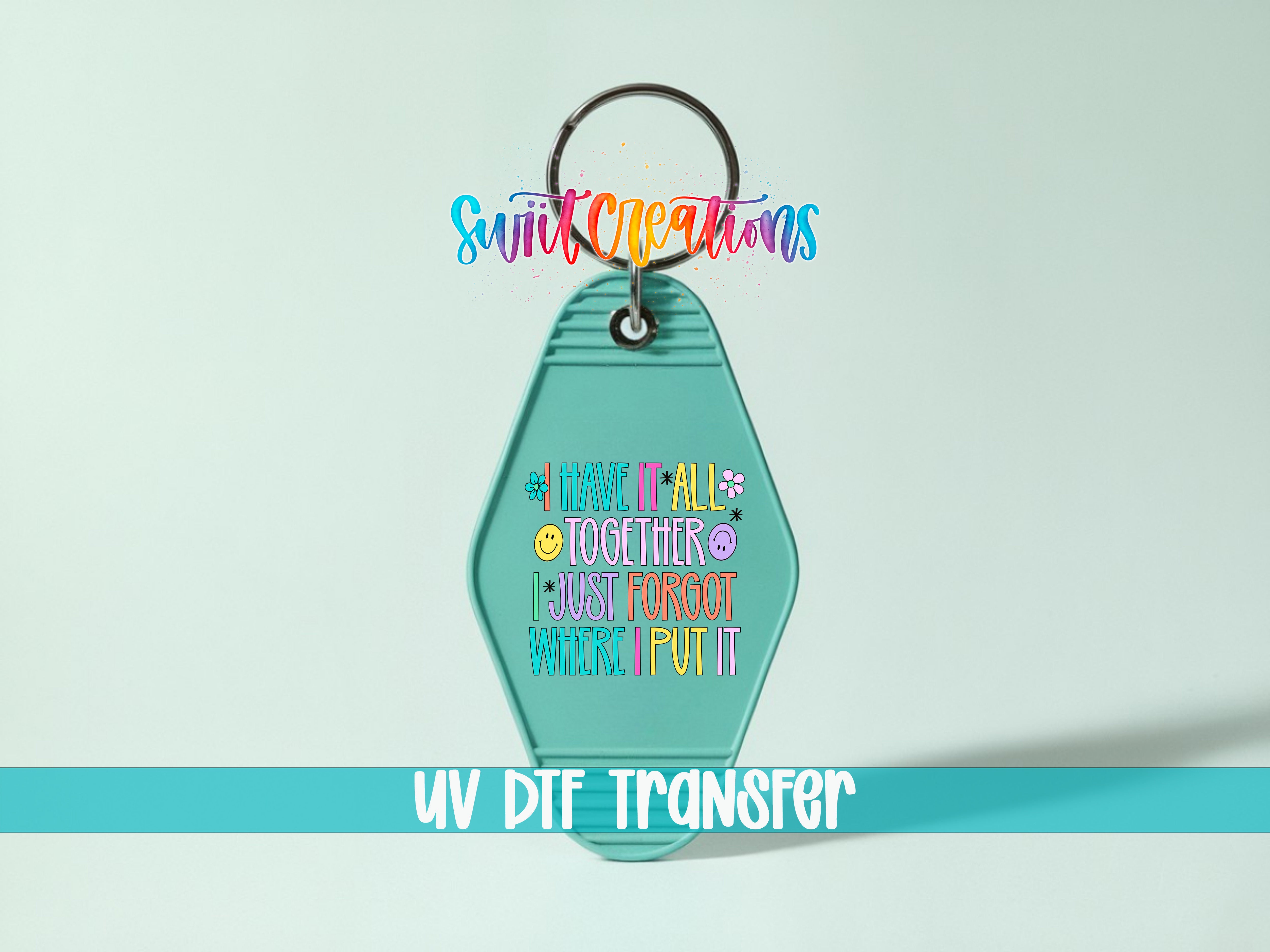 A keychain with a colorful, hand-lettered message that reads "I HAVE IT ALL TOGETHER I JUST FORGET WHERE I PUT IT" and a UV DIF TRANSFER label below it.