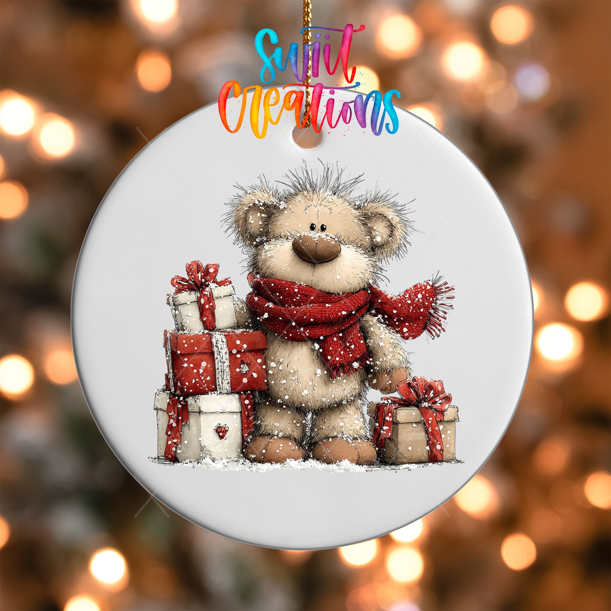 A white ornament with a teddy bear wearing a red scarf and holding a stack of red gift boxes, set against a background of blurred lights.