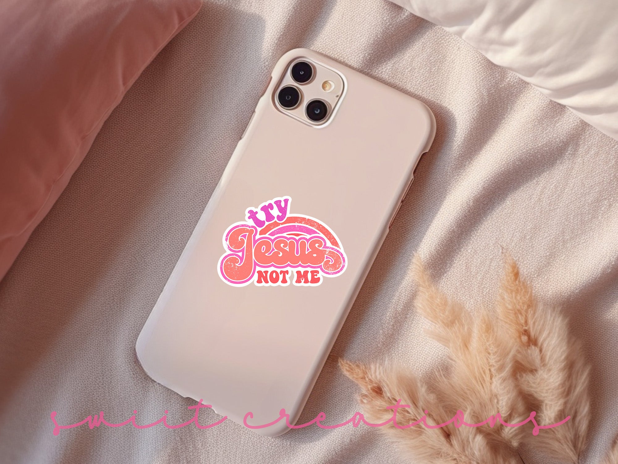 a phone case with a sticker on it sitting on a bed