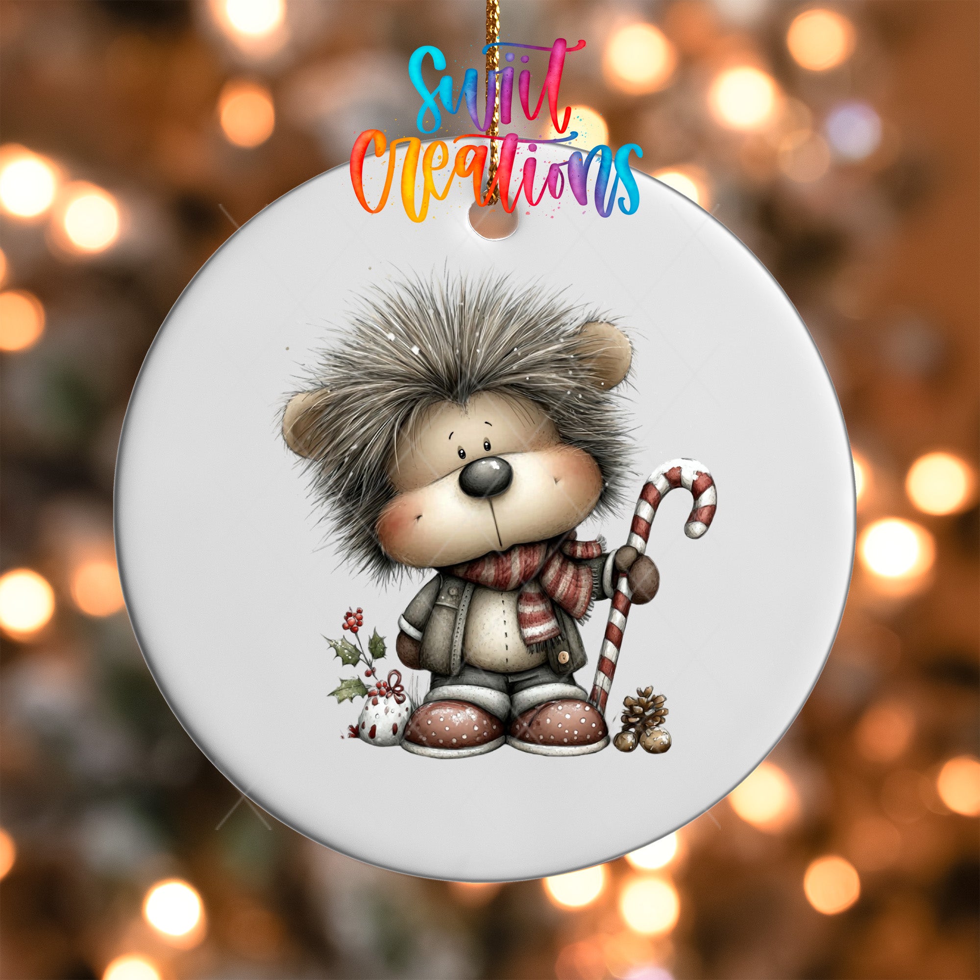 A round ornament featuring a cartoon hedgehog character with a scarf and a candy cane, set against a blurred background with Christmas lights.