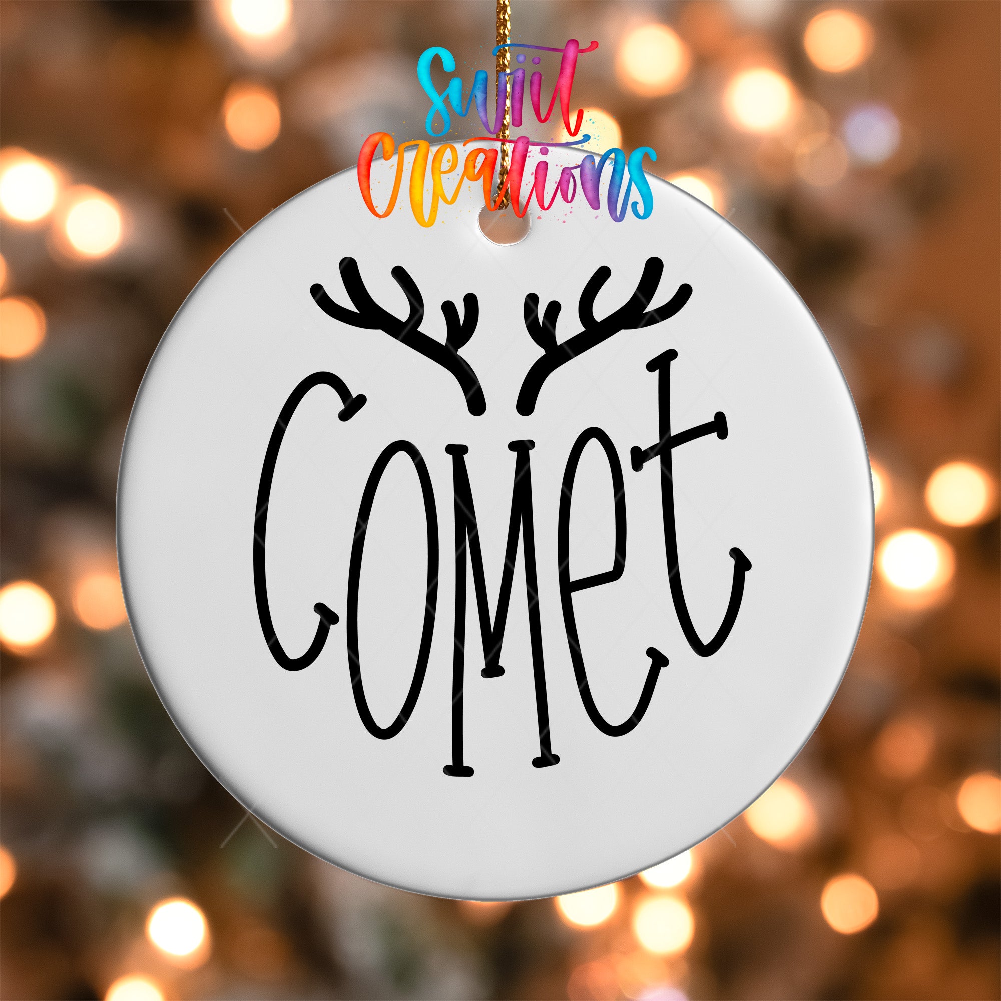 A white ornament with the word "Gomet" written on it, hanging against a background of colorful lights.