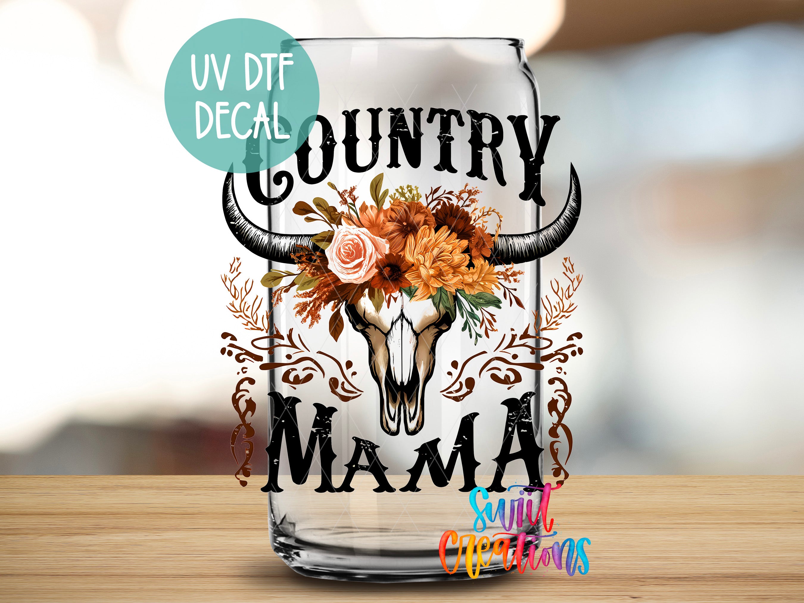 a glass with a cow skull and flowers on it