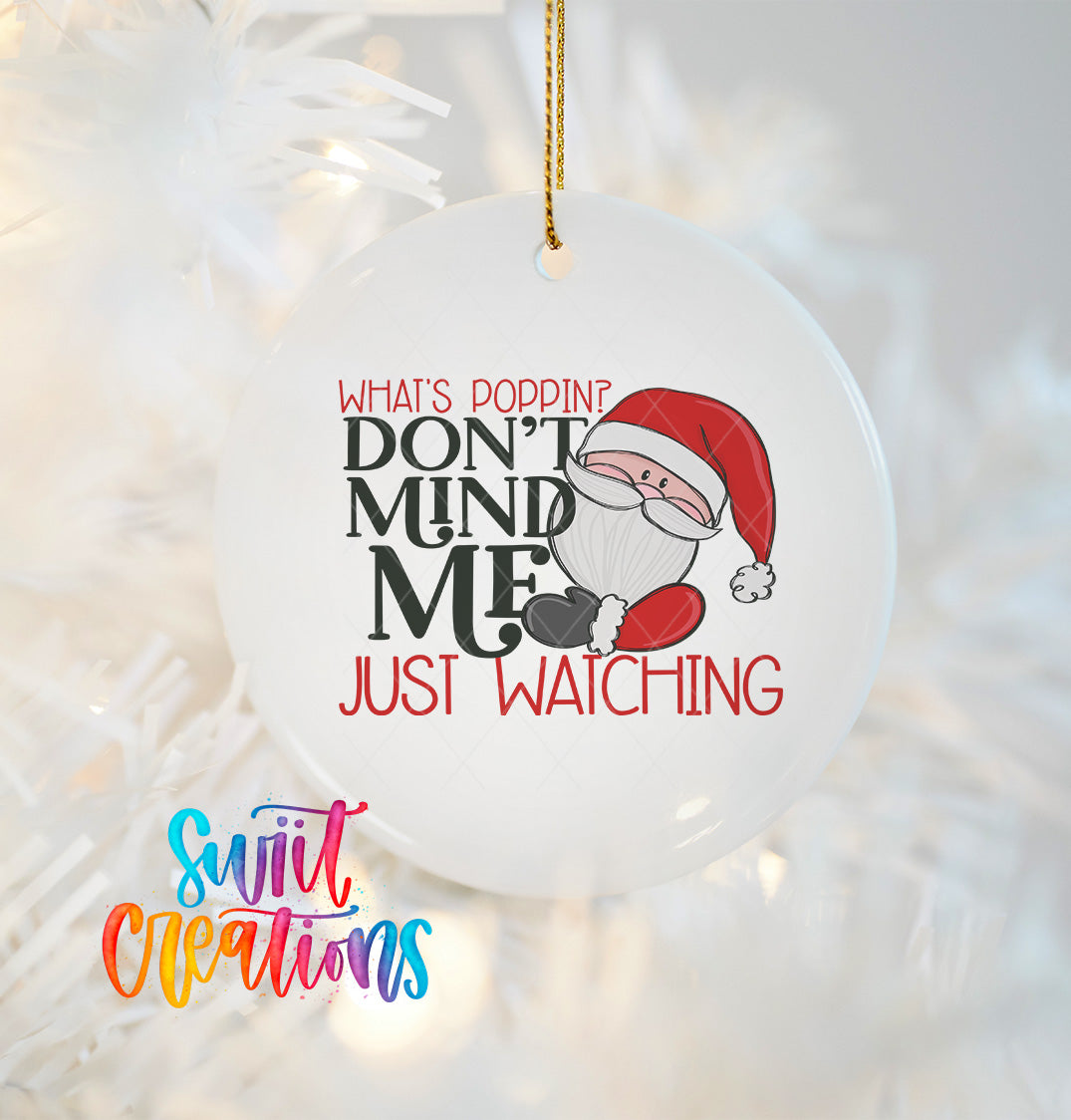 A white ornament with a Santa Claus design and text that reads "What's POPPIN? DON'T MIND ME JUST WATCHING" hanging on a string.
