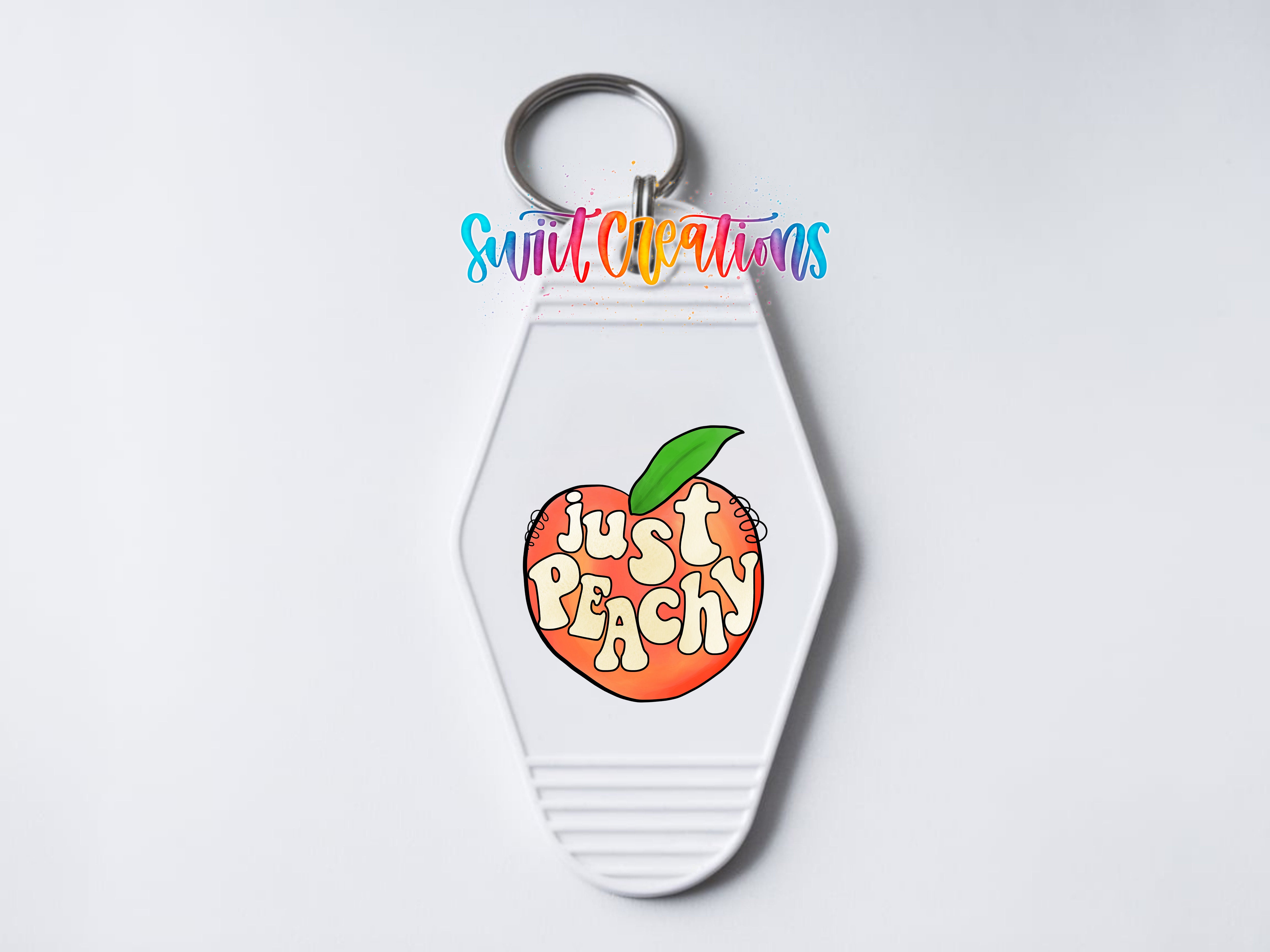 A keychain with a white hexagonal shape and a colorful graphic of an orange peach with the text "Just Peachy" on it.