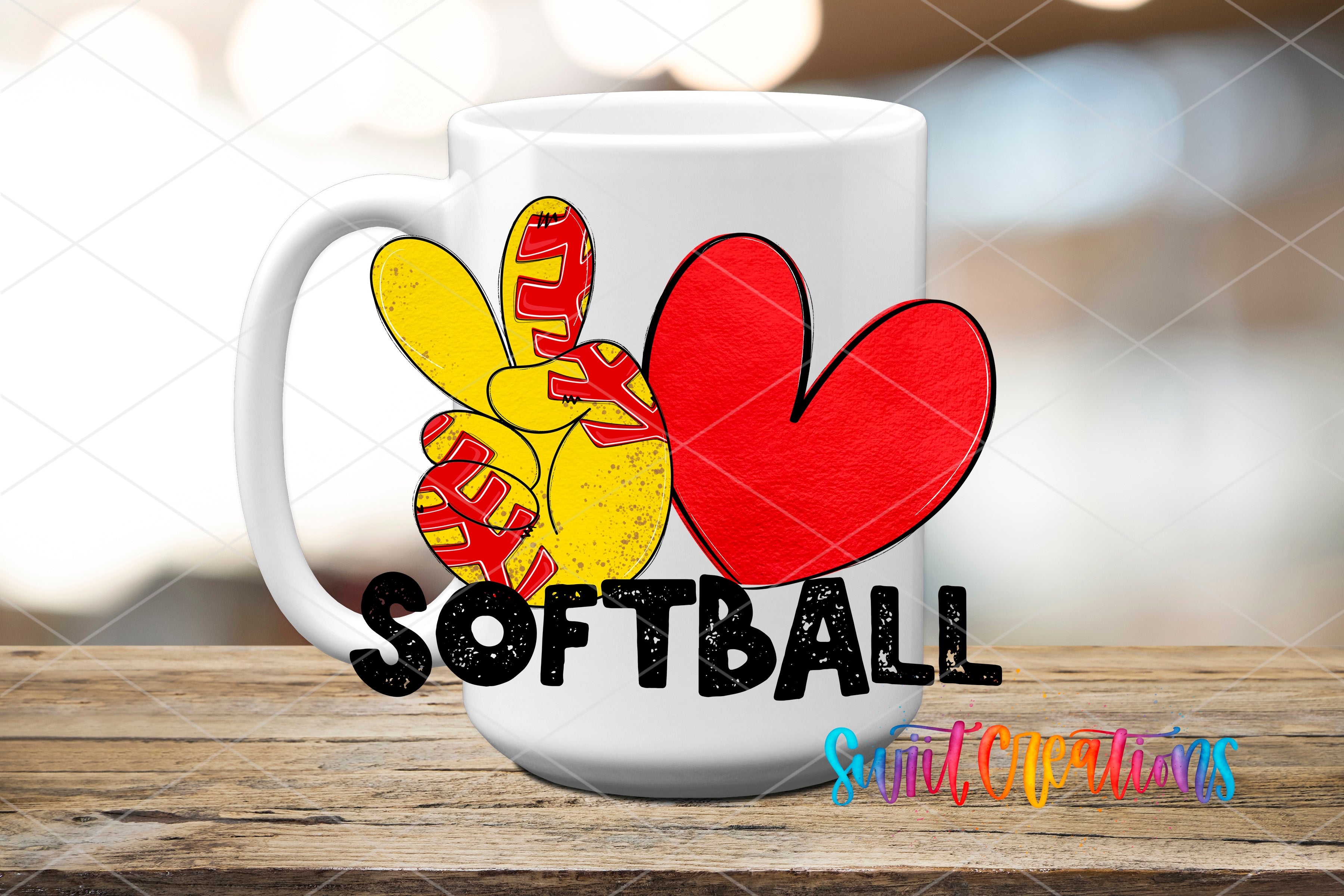 A white mug with a peace sign and a red heart, along with the word "SOFTBALL" written on it, is displayed on a wooden surface.