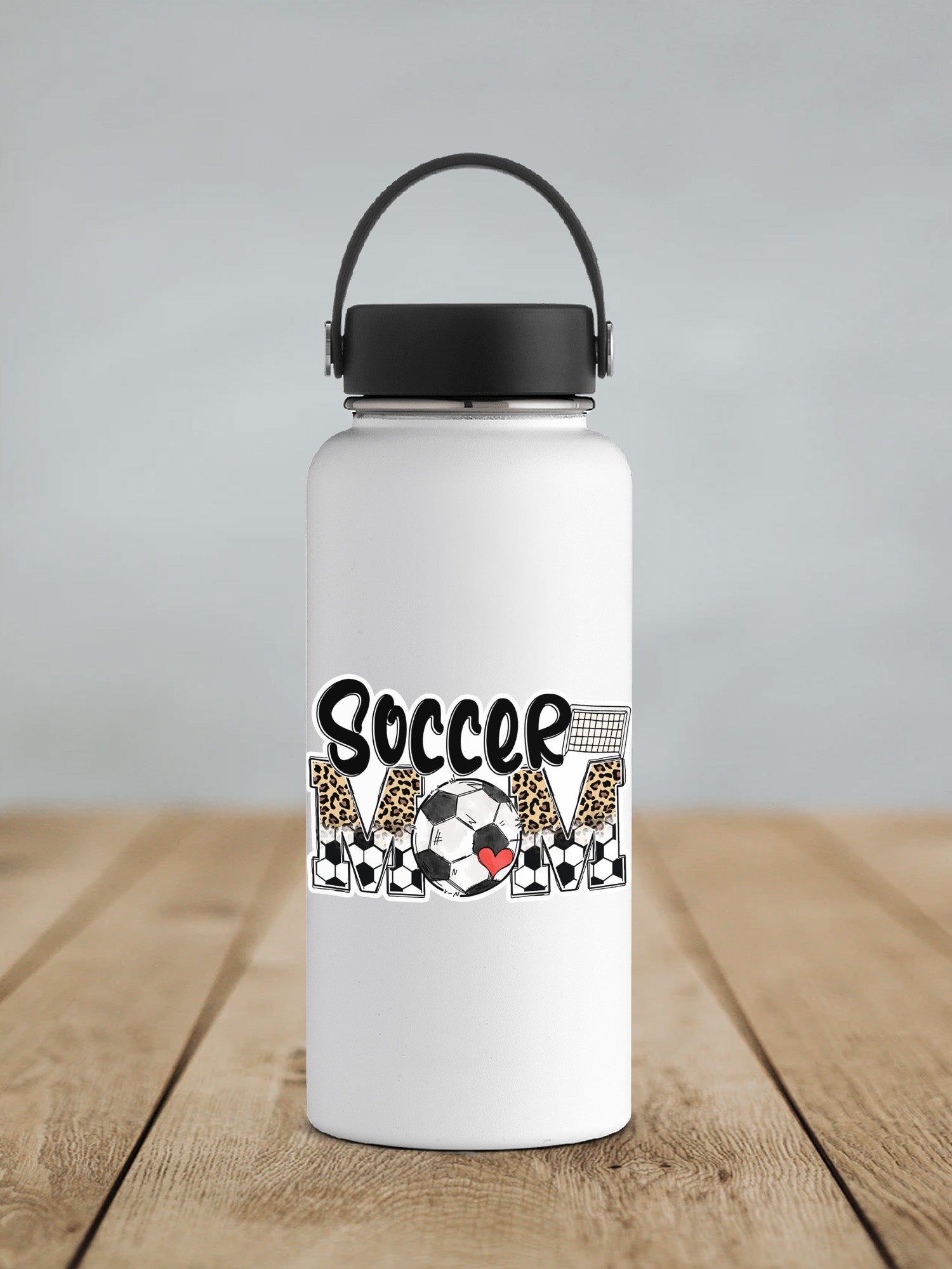 a white water bottle with a black lid on a wooden table