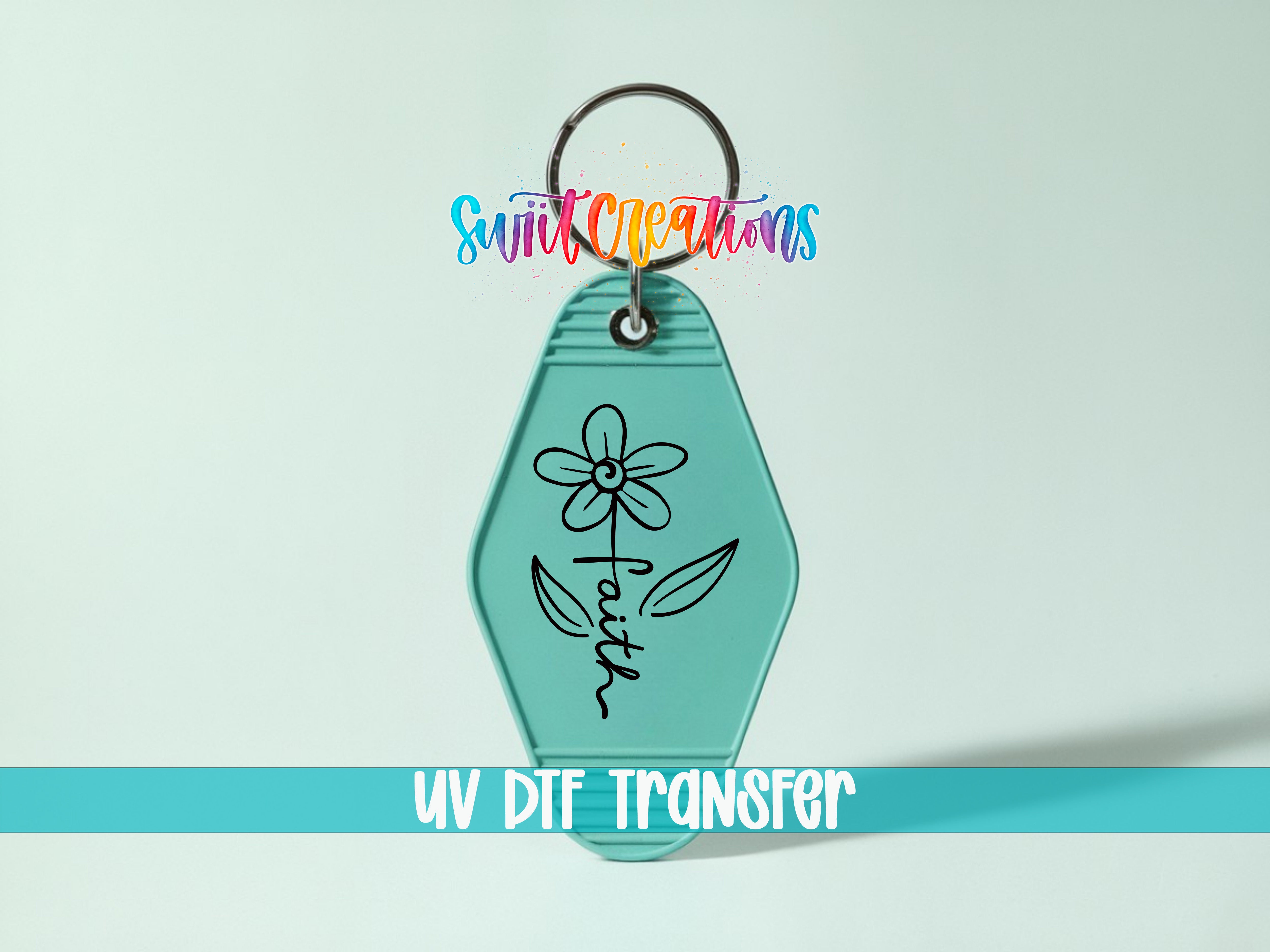 A turquoise keychain with a flower design and the word "Faith" written on it, along with a colorful logo and text that says "Sunlit Creations UV DIF TRANSFER".