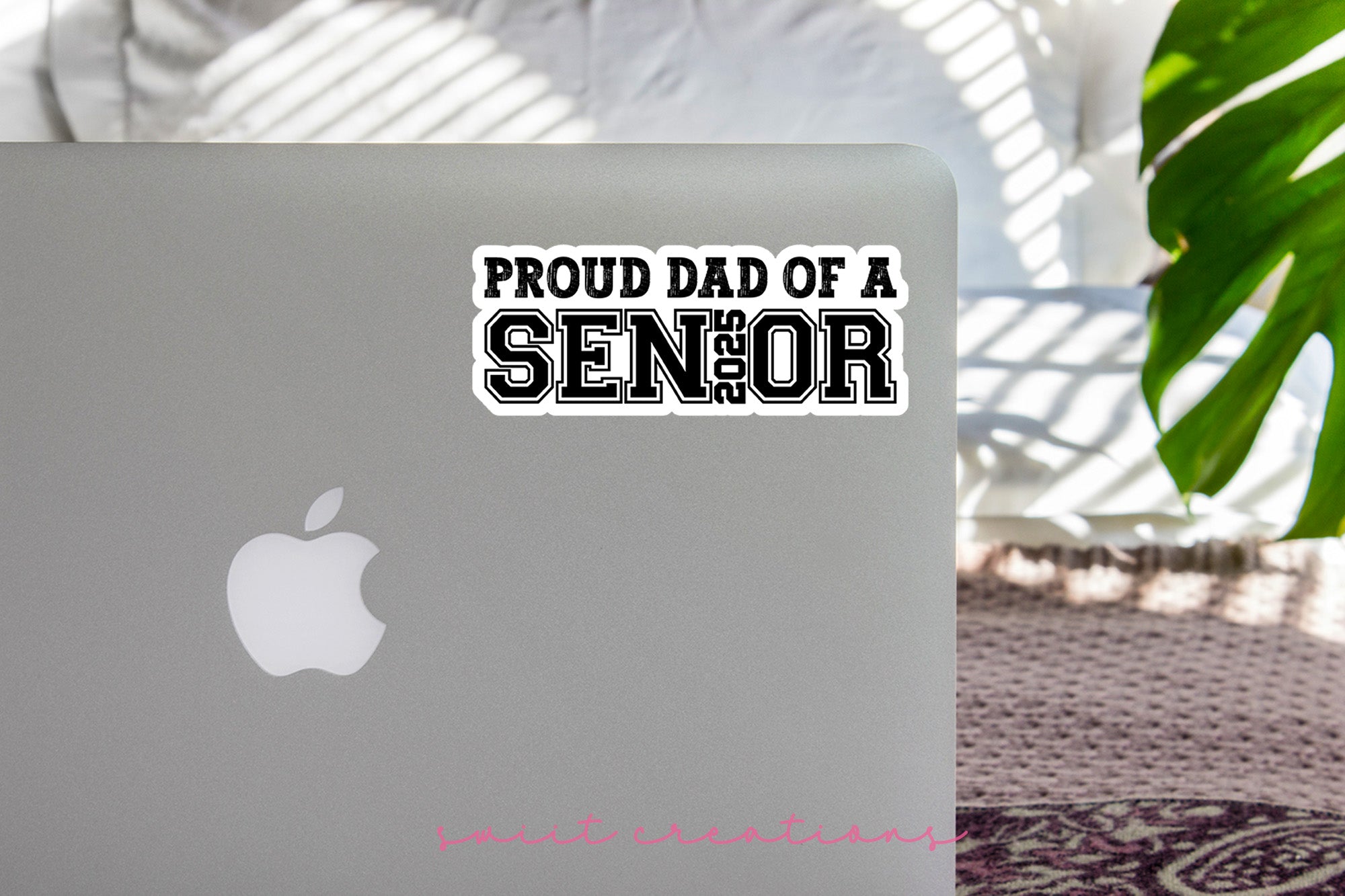 a laptop with a sticker that says proud dad of a senior
