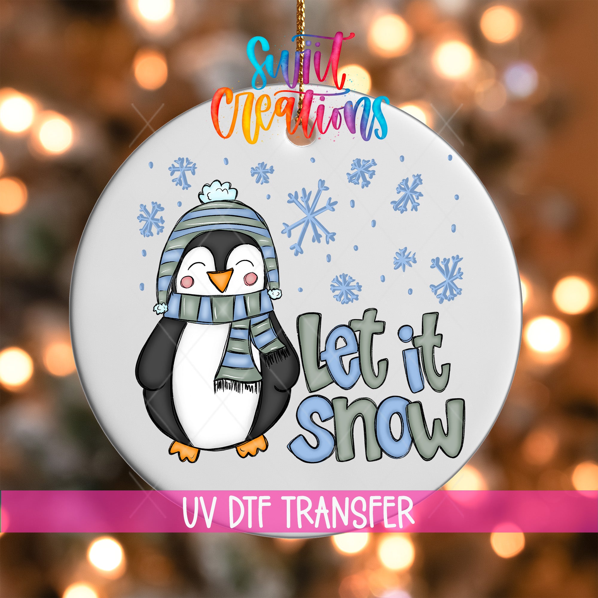 A decorative ornament featuring a cartoon penguin wearing a scarf and hat, with the text "Let it snow" written below it. The ornament is set against a background of snowflakes and twinkling lights, creating a festive winter atmosphere.