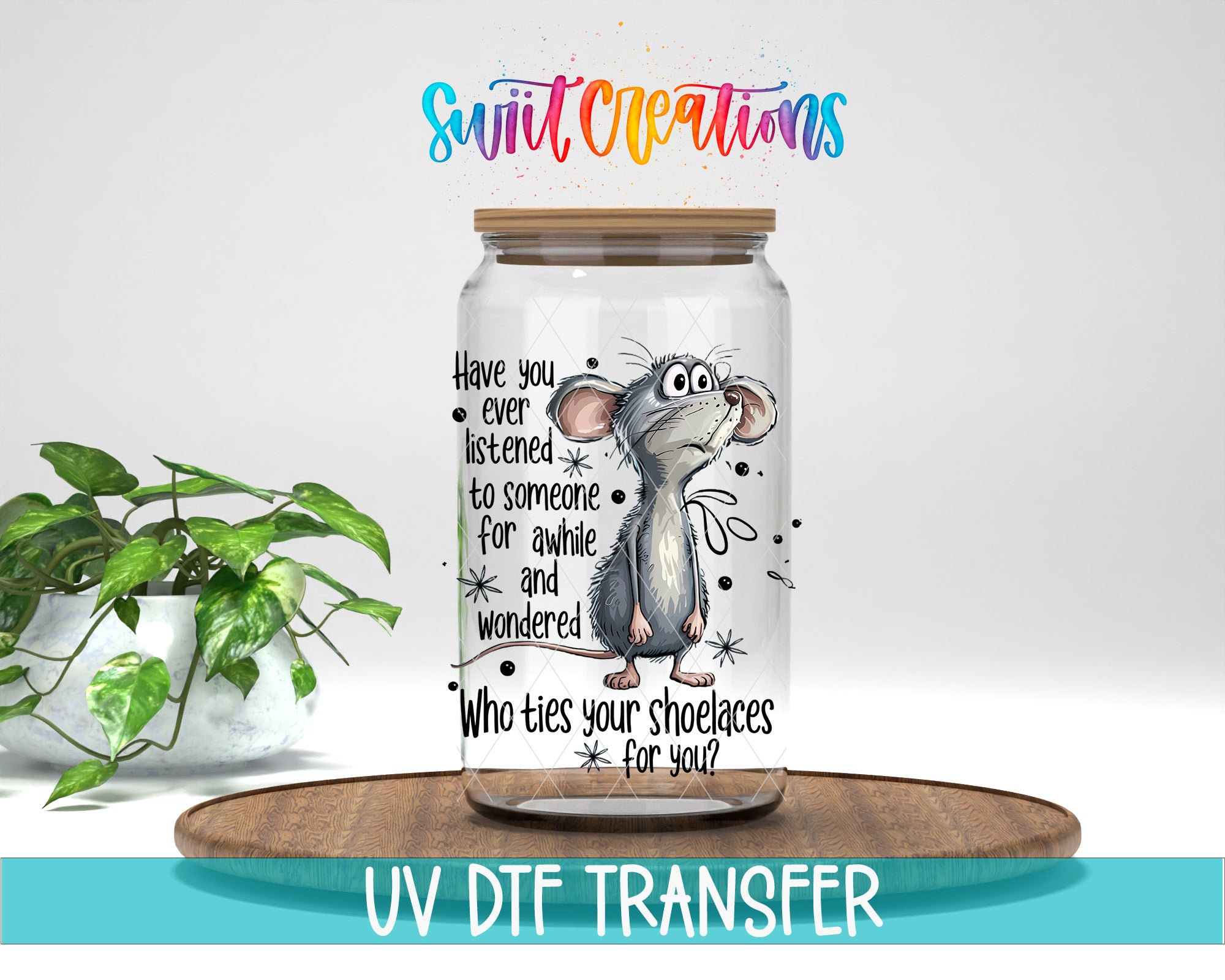 A glass jar with a cartoon mouse on it, placed on a wooden surface. The jar has text and graphics printed on it, and there is a plant in the background.