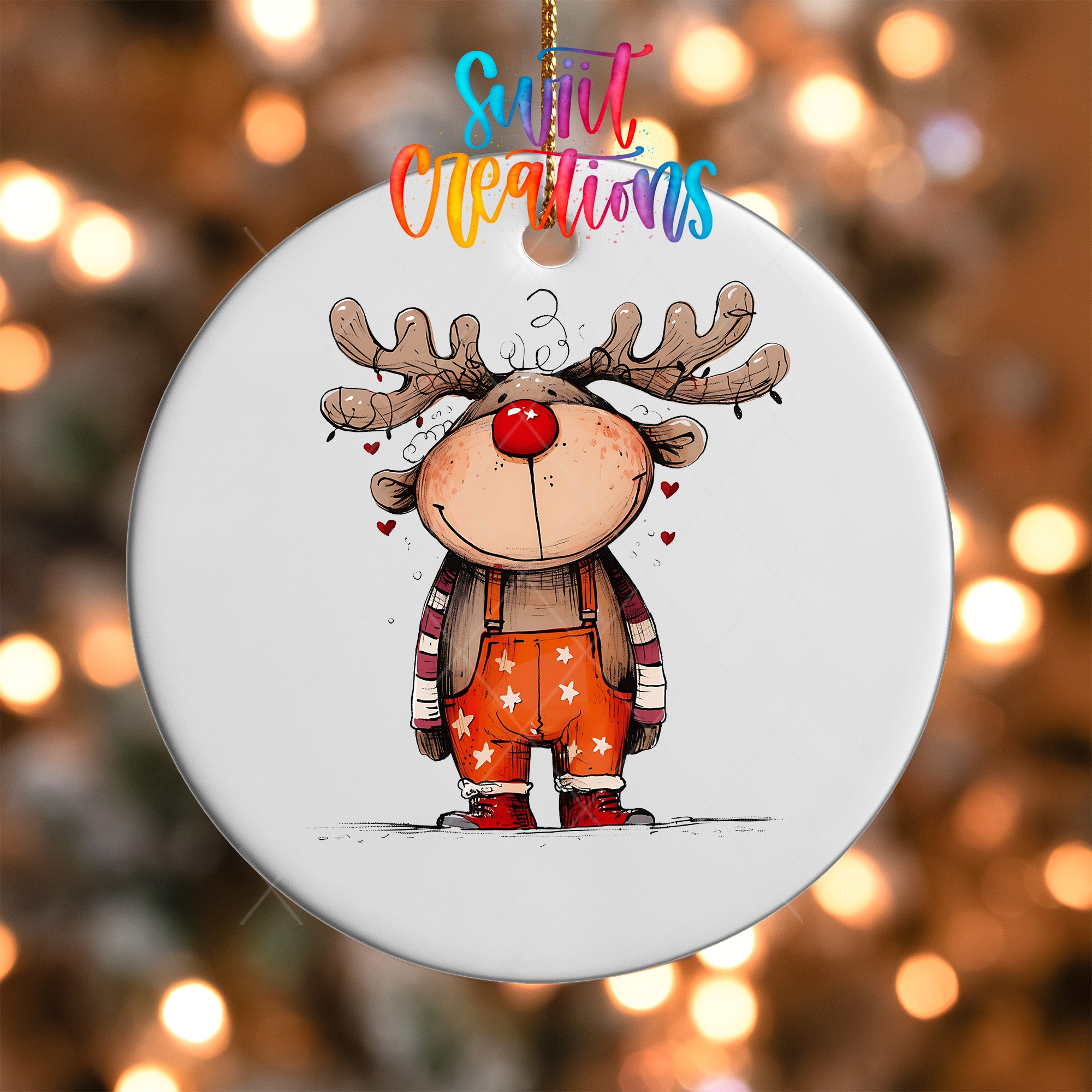 A white ornament with a cartoon illustration of a smiling reindeer wearing a red nose and striped overalls.