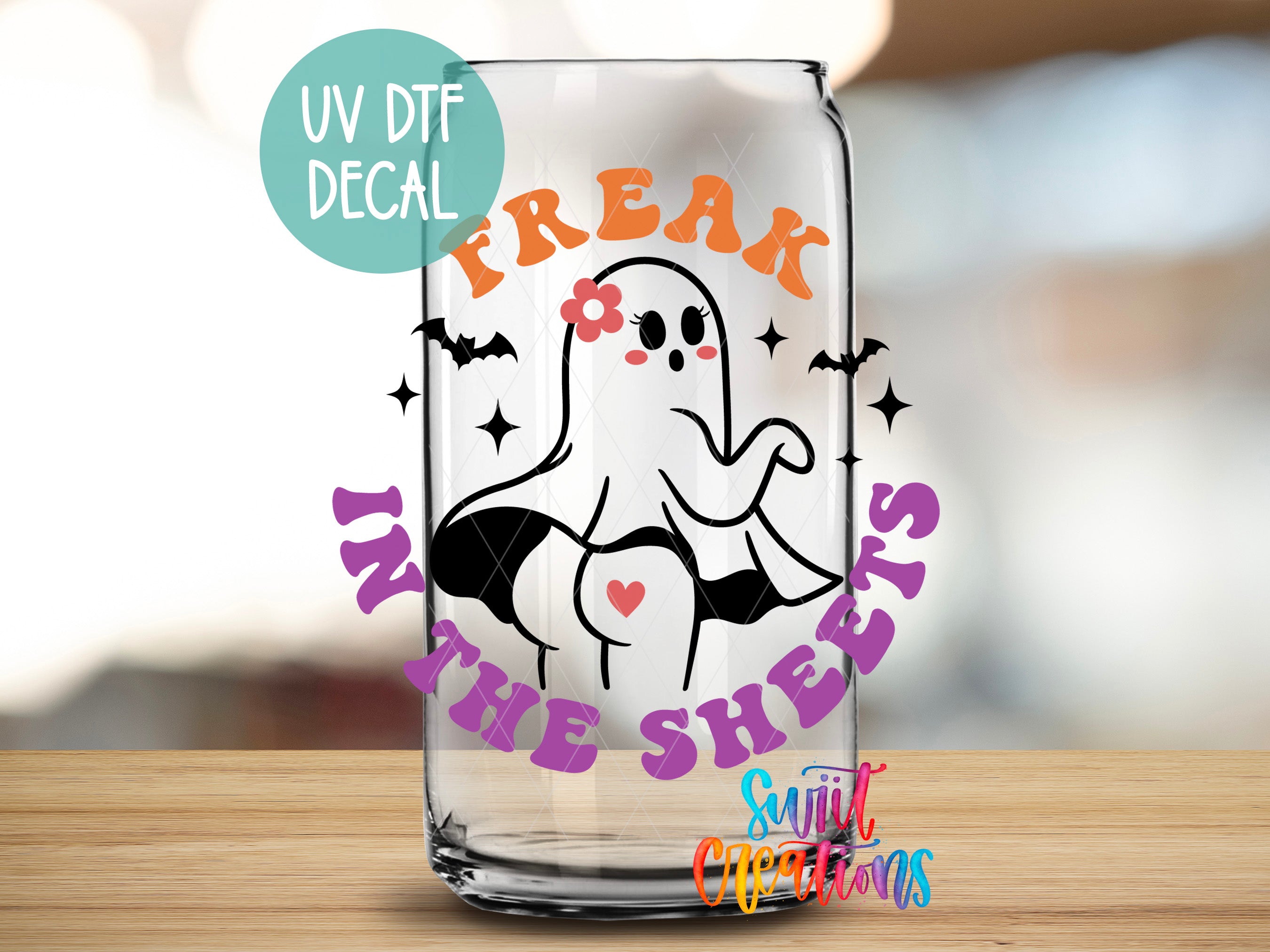 a glass with a ghost on it that says freak in the skin