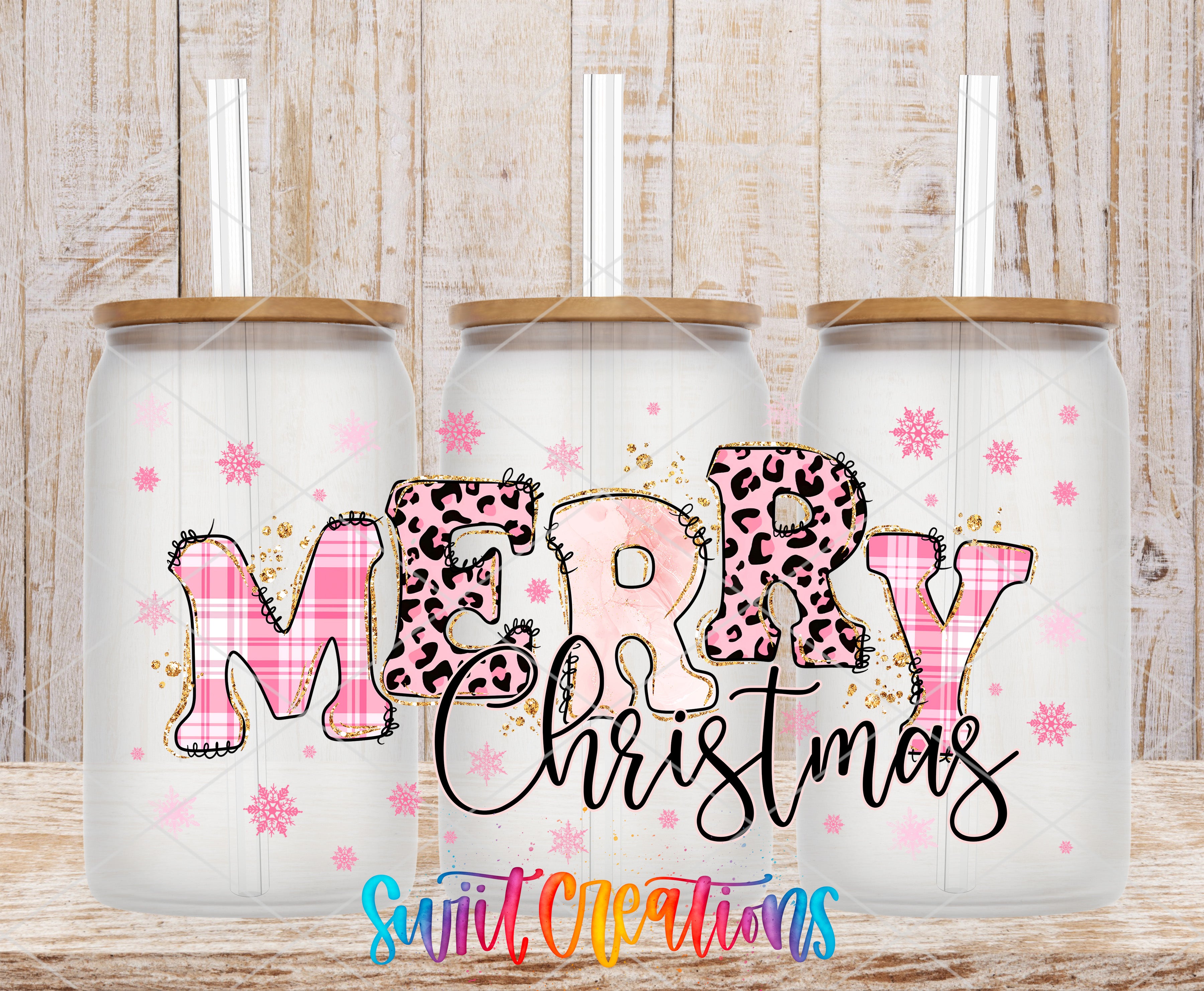 three glass tumblers with a festive "MERRY CHRISTMAS" design on them, along with snowflake decorations.