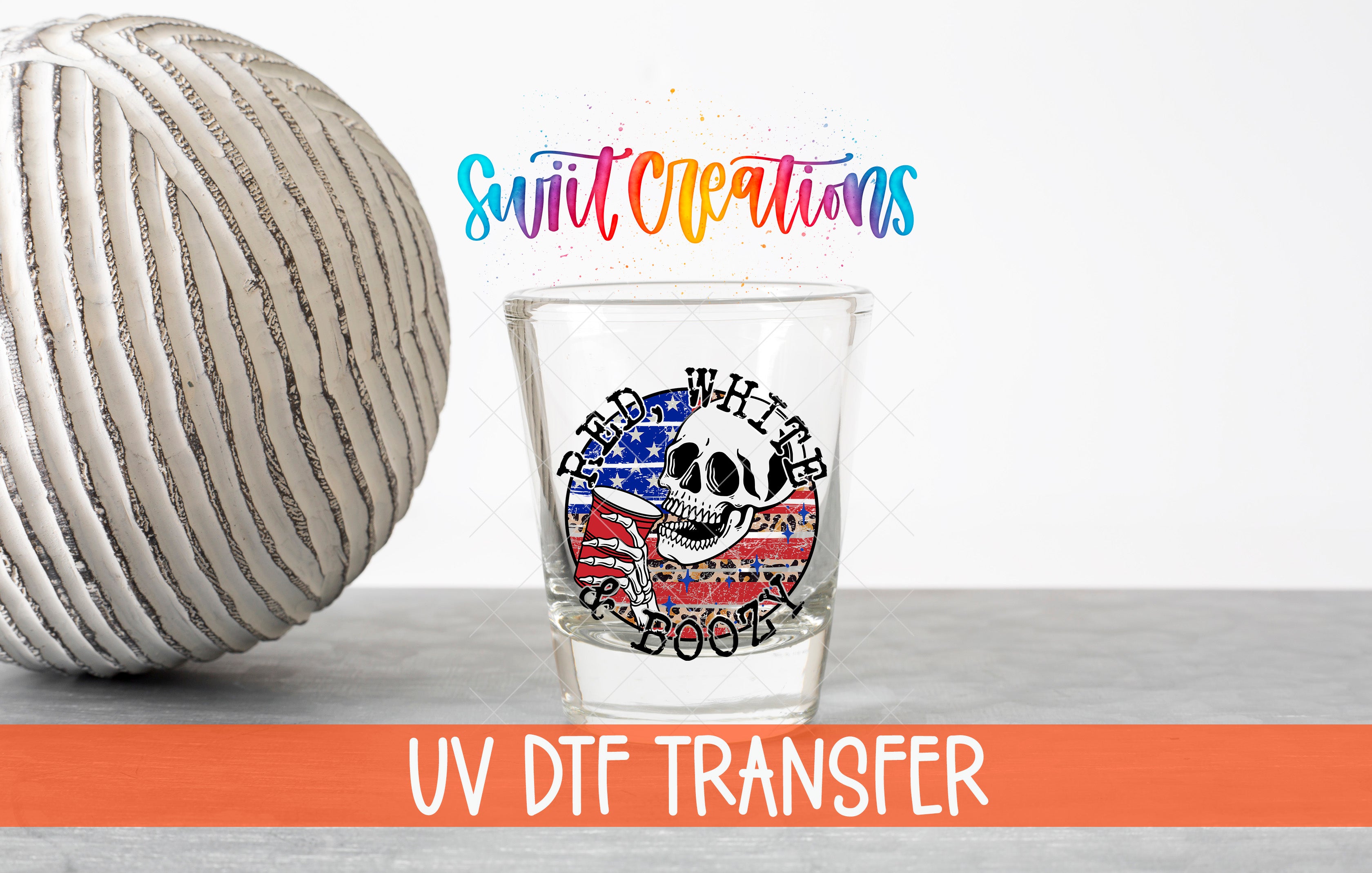 a glass with a skull design and an American flag motif, along with a text overlay that reads "Swit Creations UV Dtf Transfer".