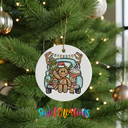 A white Christmas tree ornament featuring a gingerbread man sitting in the back of a truck, surrounded by Christmas decorations.