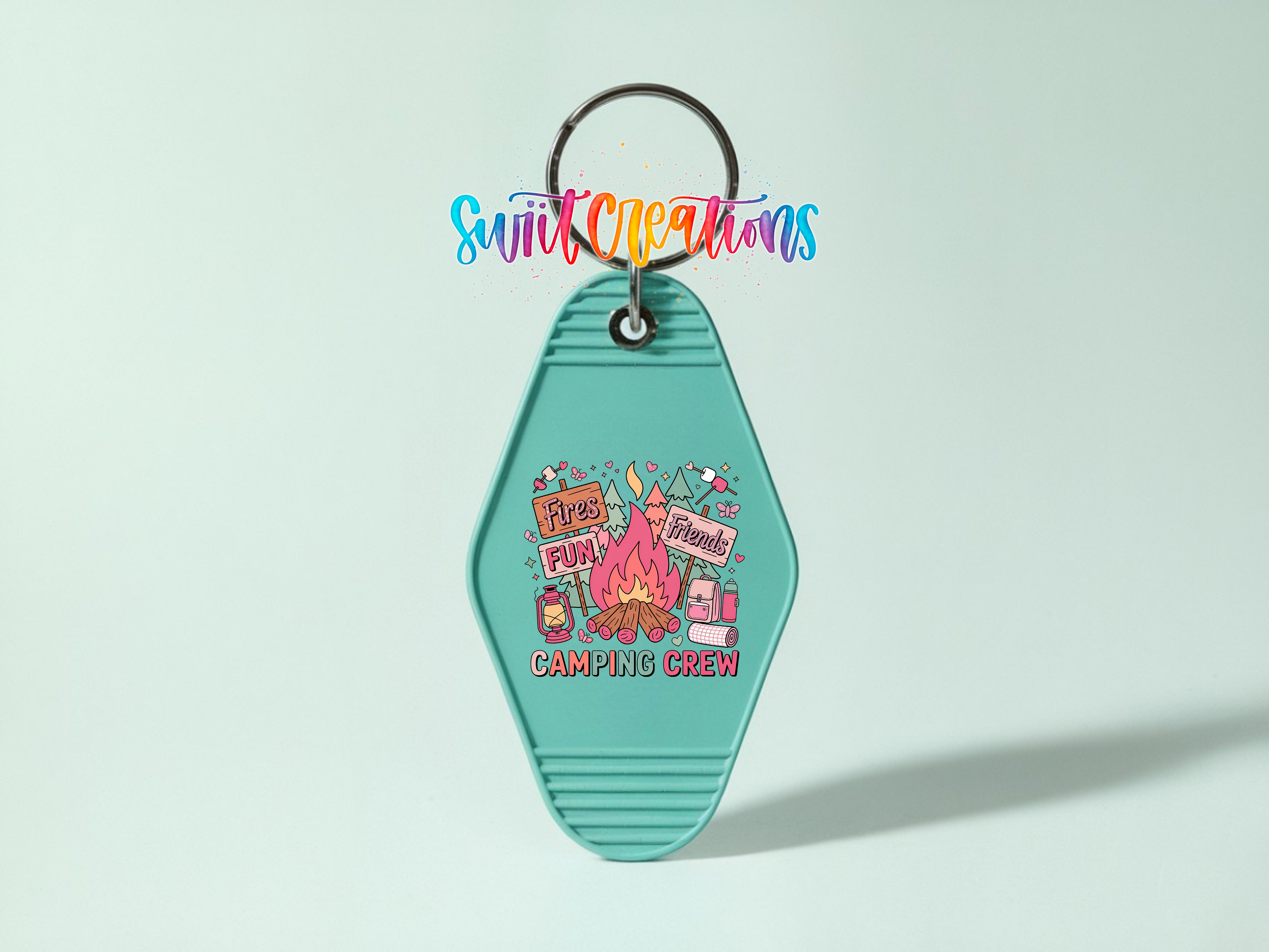 A keychain with a colorful design featuring a campfire, camping equipment, and text that says "Please Fun Fun Fun Friends Camping Crew".