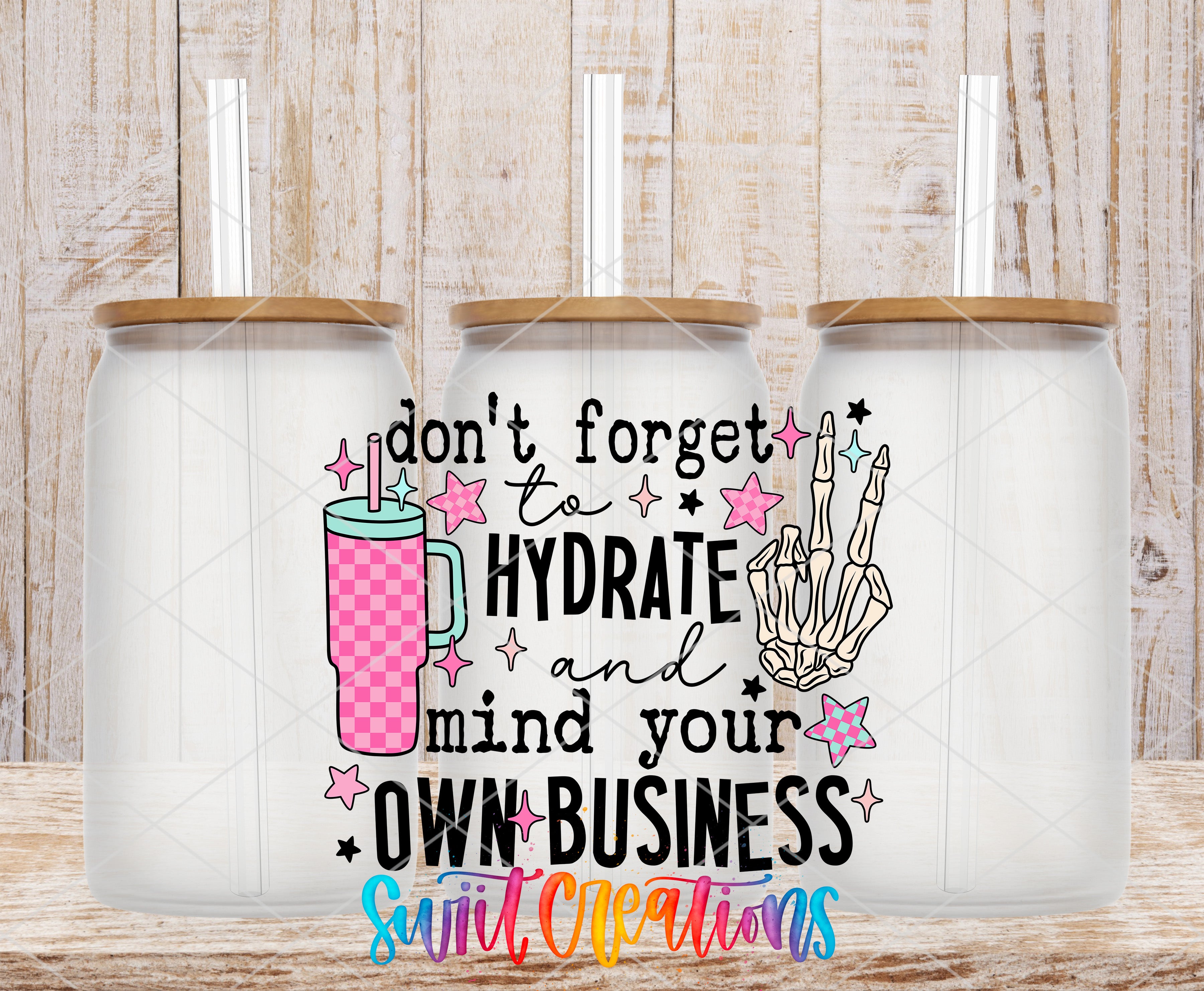 three glass jars with lids, each containing a straw. The jars are arranged in a row, and there is a text overlay on the jars that reads "don't forget to hydrate and mind your own business".