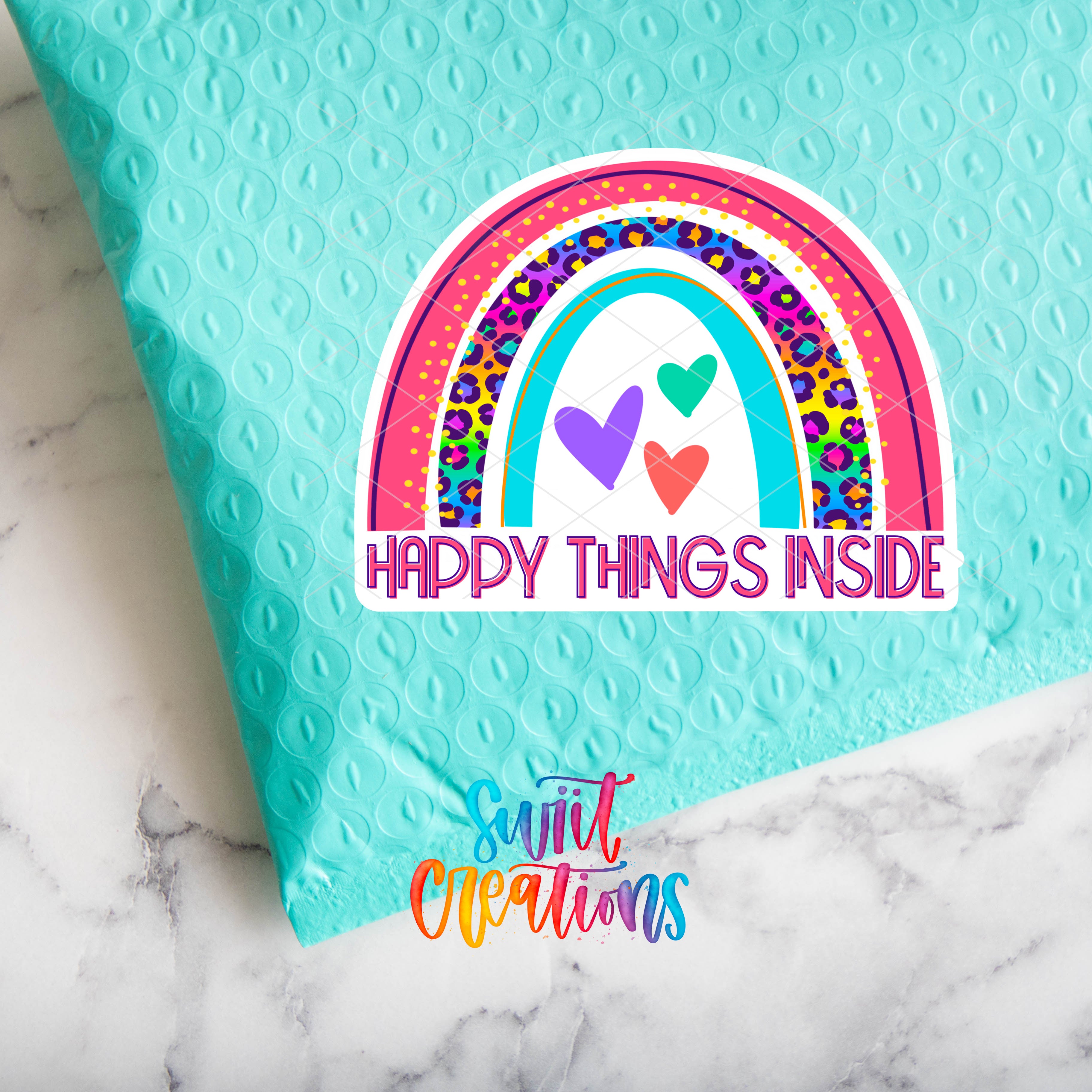 a blue bag with a rainbow and a happy thing inside sticker on it