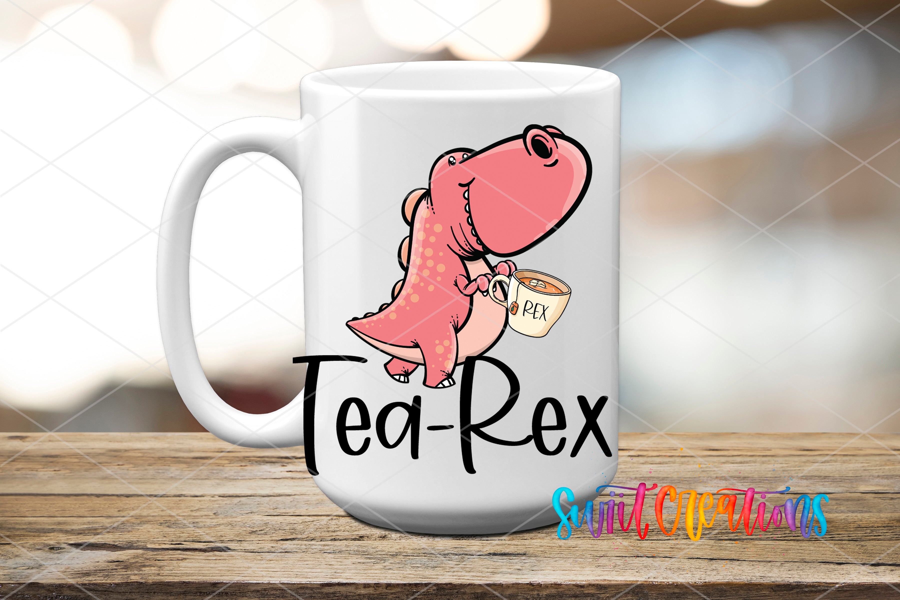 A white mug with a cartoon dinosaur holding a cup labeled "Tea-Rex" and the text "Suit Creations" below it.