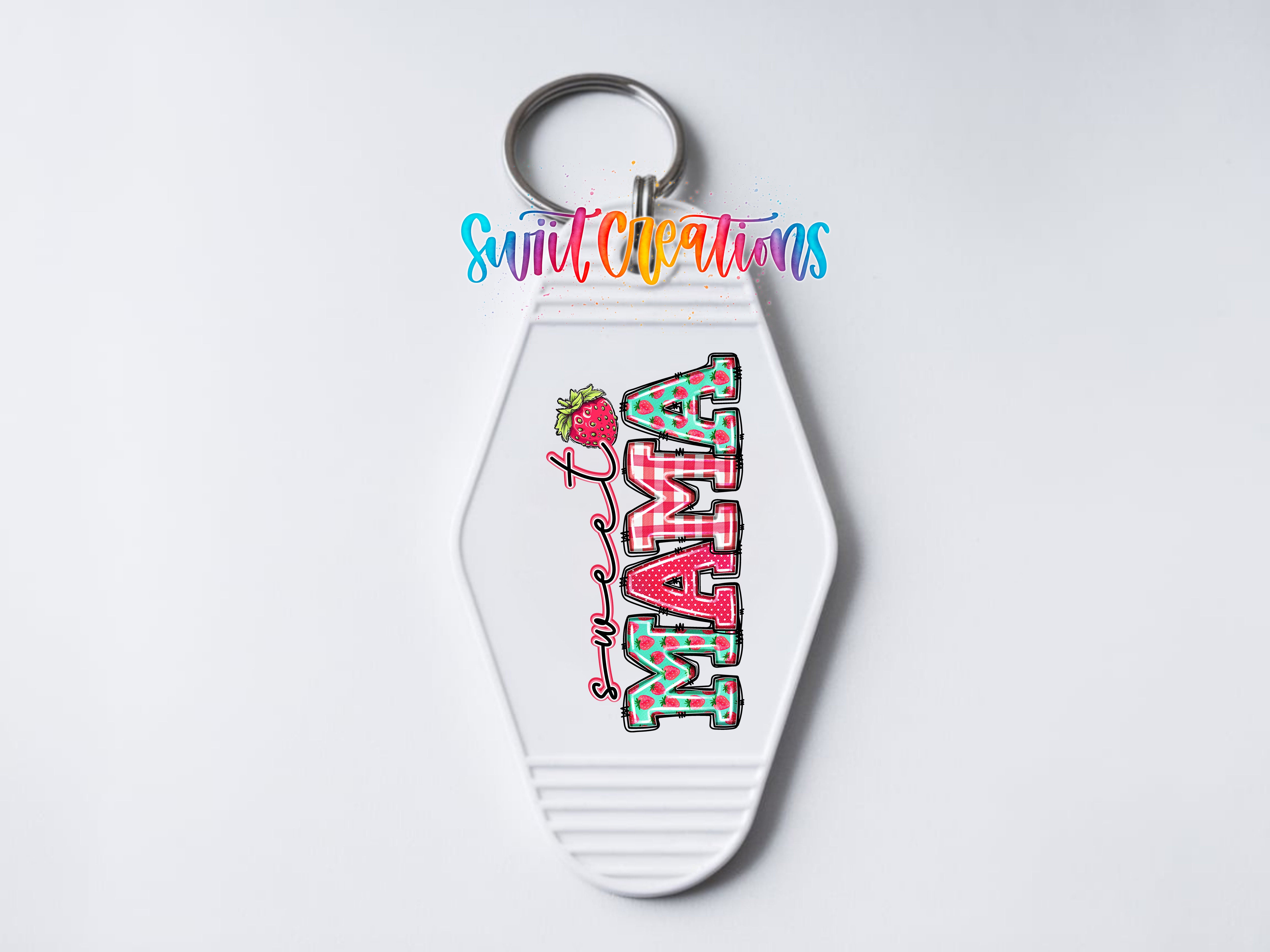 A keychain with the word "MAMA" printed on it, along with a strawberry graphic.