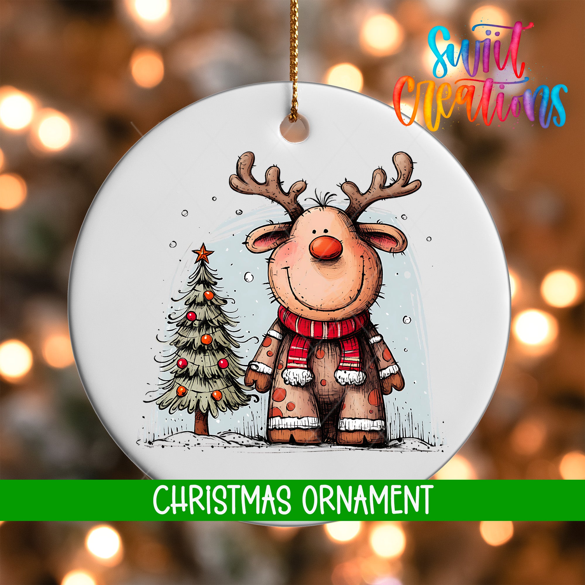 A white Christmas ornament featuring a cartoon reindeer standing next to a Christmas tree.